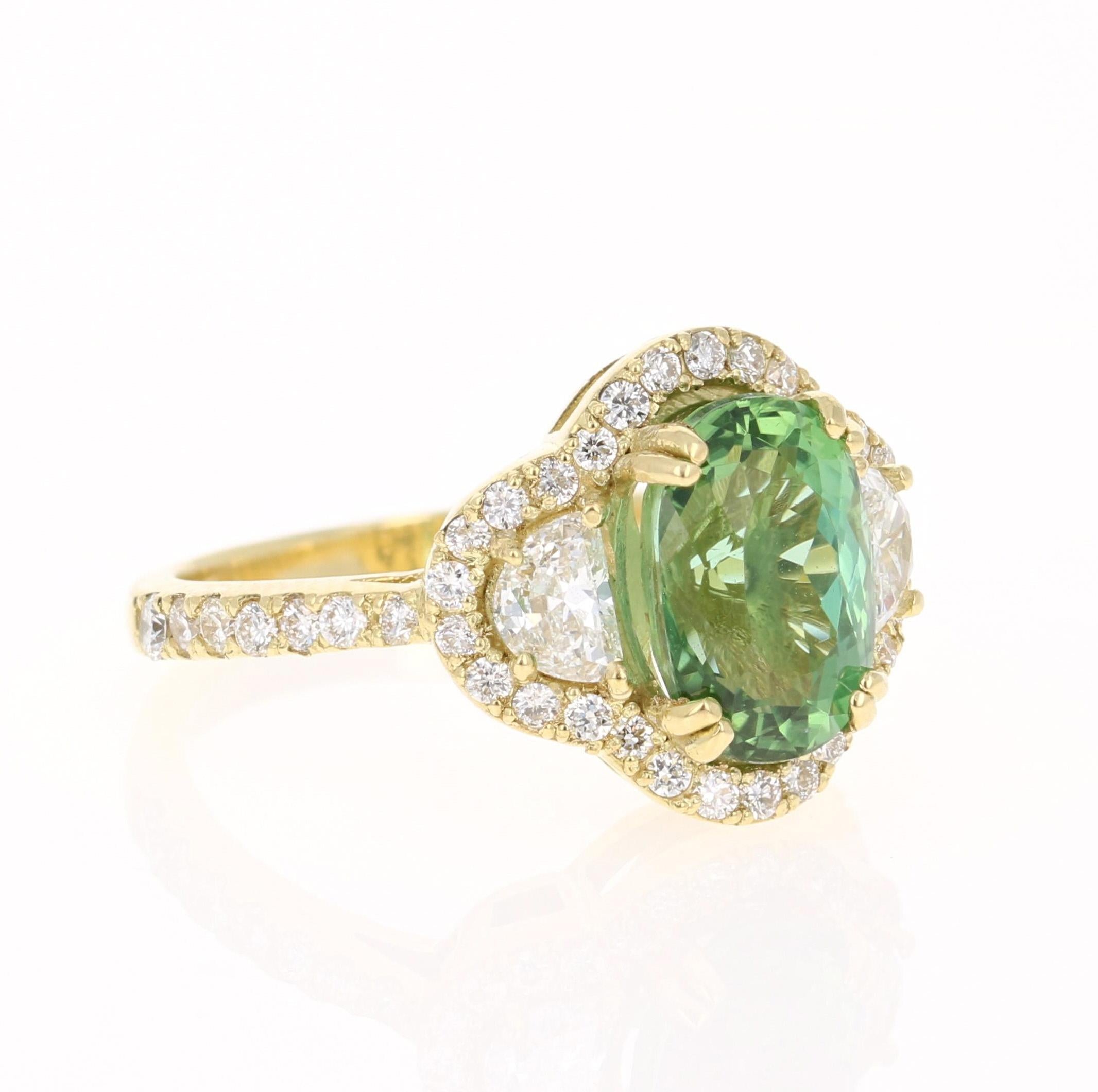 A unique beauty that is sure to be a rare and gorgeous design! Very much inspired by the articulate designs of the art-deco era.

This stunner has a gorgeous Oval Cut leafy Green Tourmaline that weighs 3.06 Carats. Adjacent to the tourmaline are 2