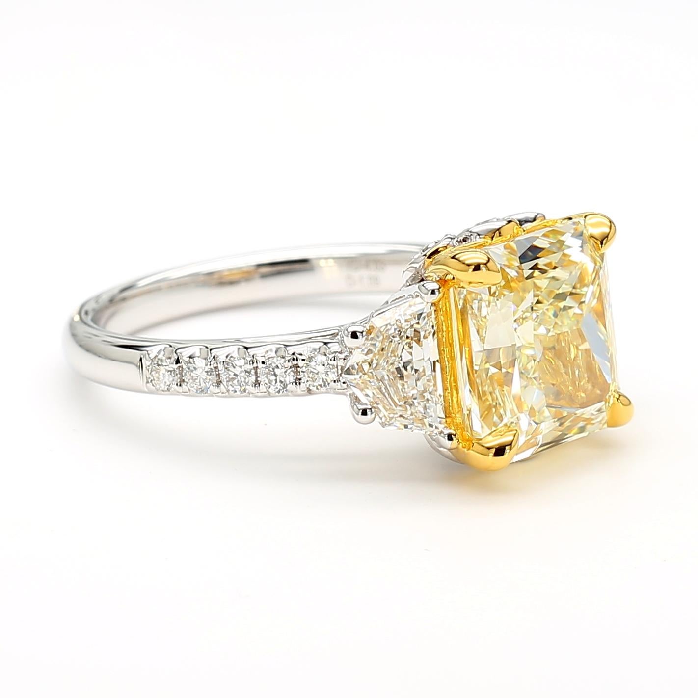 This very impressive Yellow Diamond Square Radiant Cut Three Stone Ring is a testament to fine craftsmanship and timeless design. Perfect for those who appreciate the beauty of natural diamonds, this ring offers a balance of luxury and tasteful