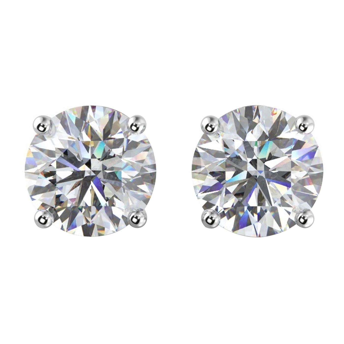 These 4.02ct natural round cut diamond stud earrings are held in a 14K White Gold four-prong setting and are mounted on a tapered basket to get the flush look when worn. Each earring has a push back allowing for greater comfort and fit. Diamond