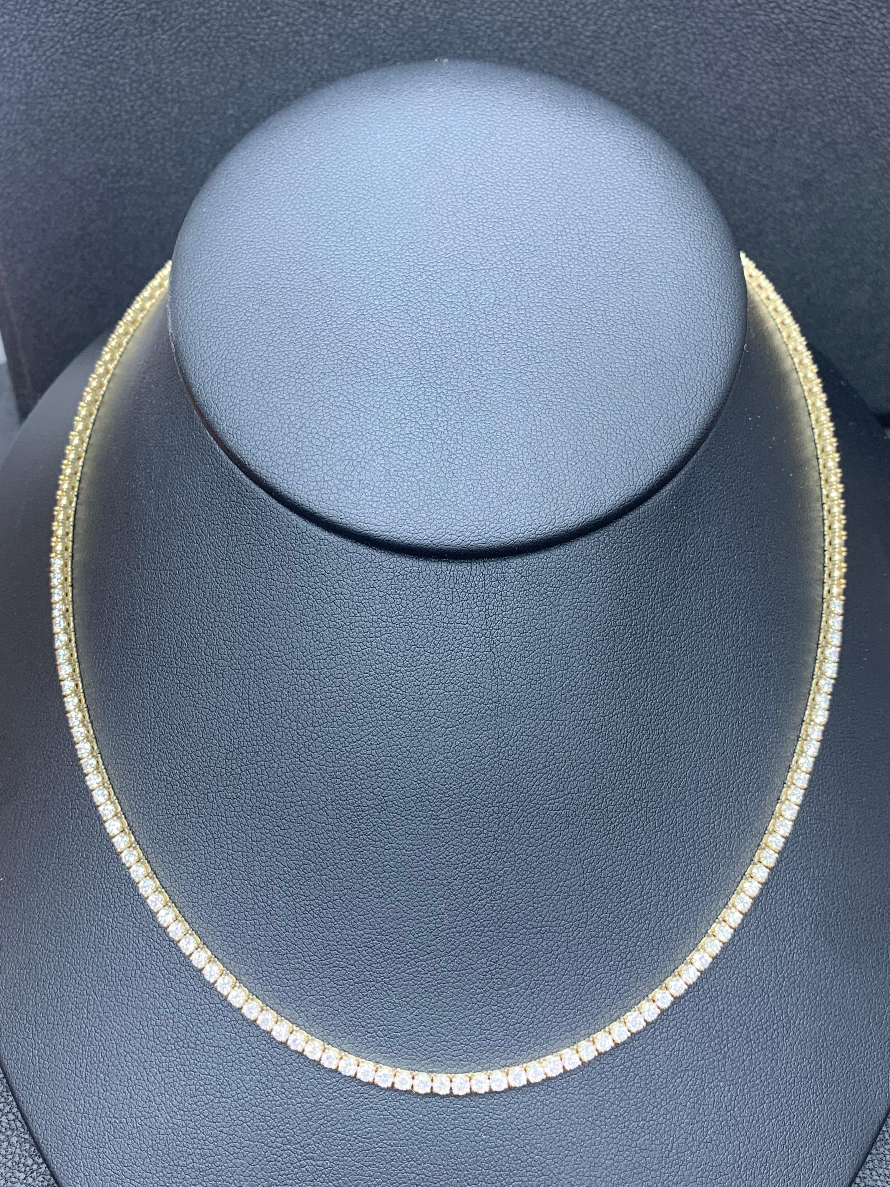 Showcasing a line of half diamond and half metal round brilliant diamonds that elegantly set in a 4 prong setting. 81 Diamonds weigh 4.03 carats total and is set in 14 karat yellow gold. 