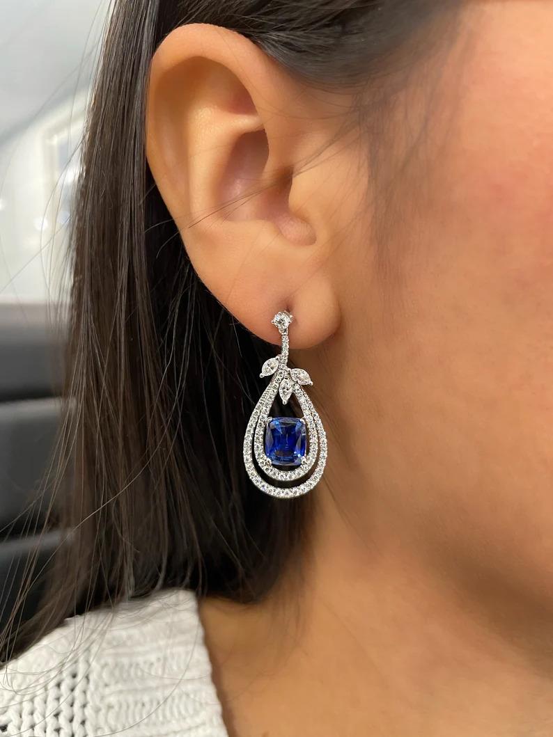 These stunning sapphire & diamond earring feature 2 cushion shape sapphires weighing 4.03cts and diamonds weighing 2.08cts set in 18k white gold.