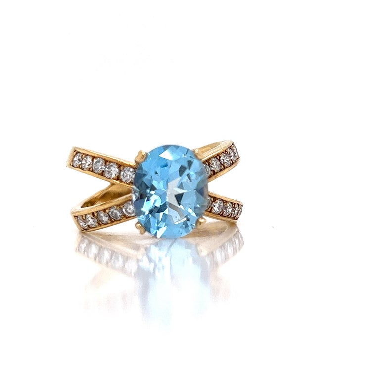 December Birthdays and blue topaz collectors will enjoy this vintage ring.  A classic design with a 4.03 oval blue topaz.  7 grams of 18 K yellow gold.  1.0 cttw of  VS-SI clarity, G-H color round diamonds.  This is a US size 7.5 and can be sized. 