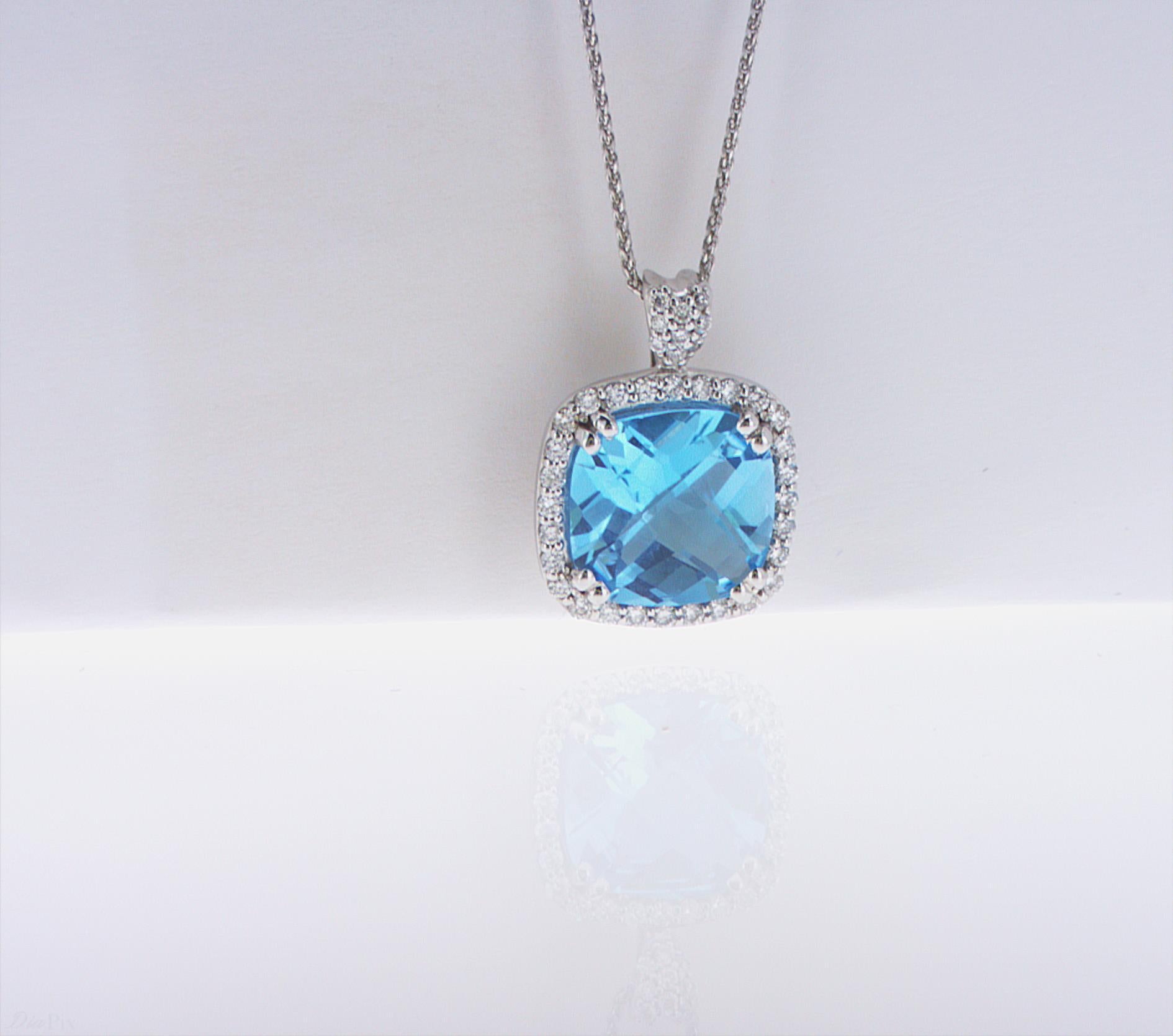4.03ct Cushion Cut Blue Topaz in a 14k WG Setting, featuring 0.26ct total weight of accent Diamonds. 18