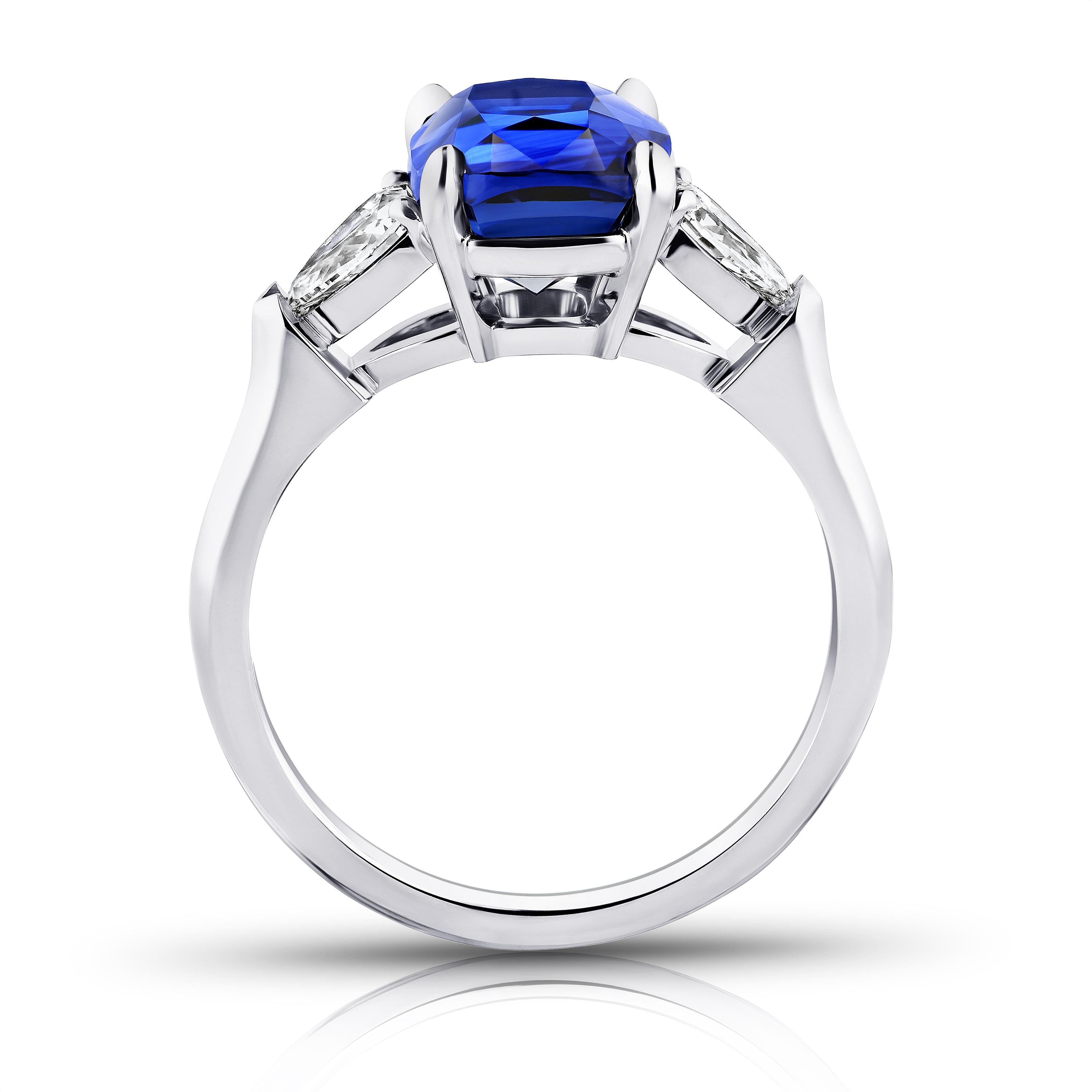 4.04 carat cushion blue sapphire with arrow shape diamonds .51 carats set in a platinum ring. Size 7. Free resizing to your finger size. 