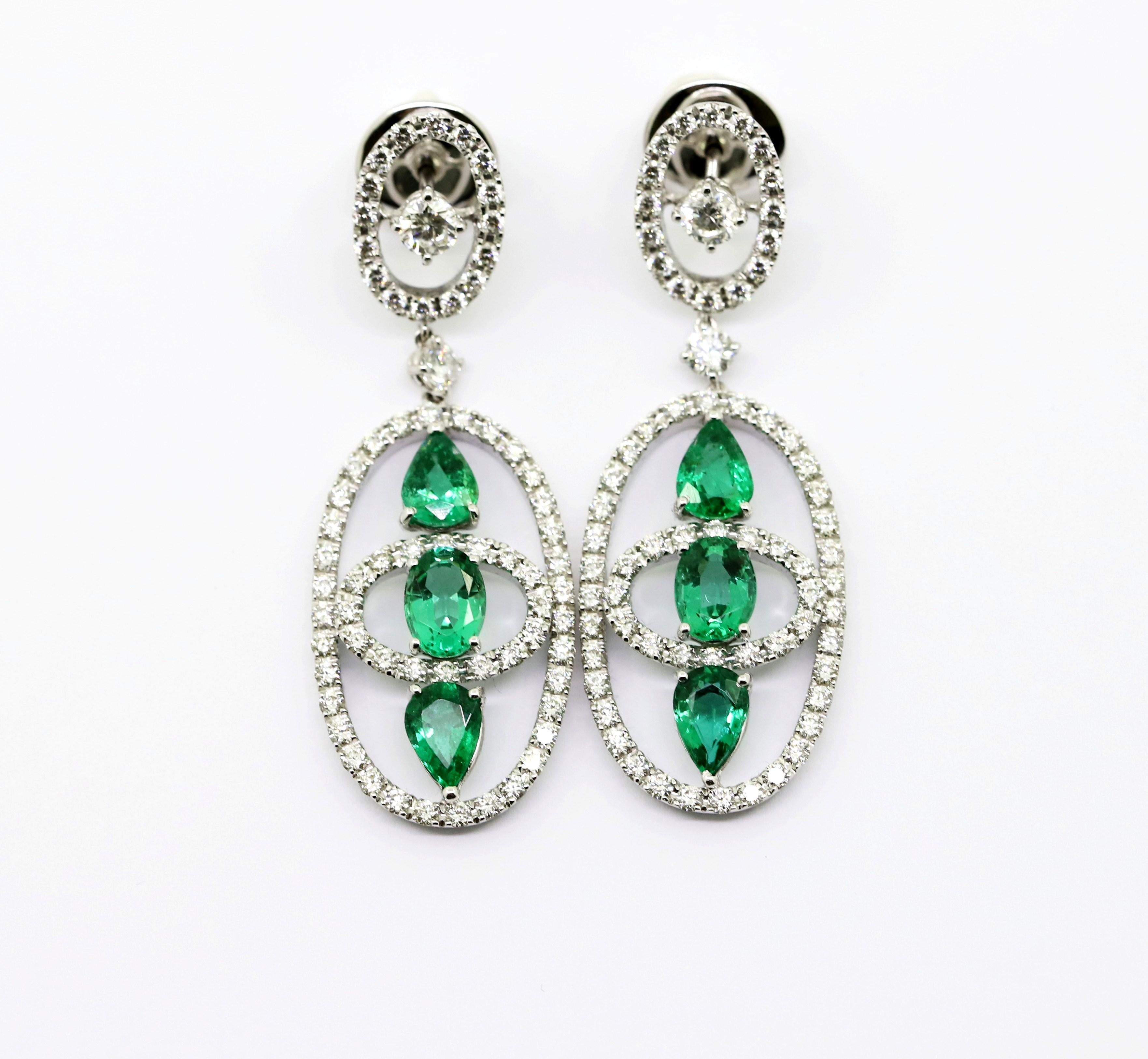 Geometric shapes reminiscent of a satellite.

6 Pear and Oval Shaped Emeralds for 4.04 Carat Total Weight in the Pendant of thise Dangle Earrings,
 framed by 136 pcs Natural White Diamonds for 3.06 Carat Total.

This jewel is entirely Hand-Made in