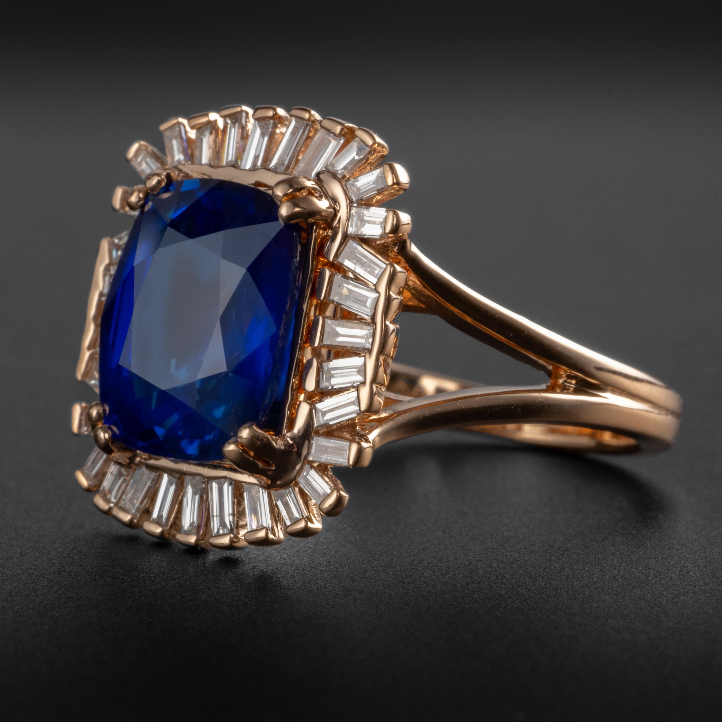 A mixed cut cushion-shaped 4.04 unheated royal blue sapphire from Madagascar is the center of attention in this glamorous rose gold cocktail ring. The sapphire is surrounded by a fan of 32 tapered baguette diamonds weighing a total of .50 carats.