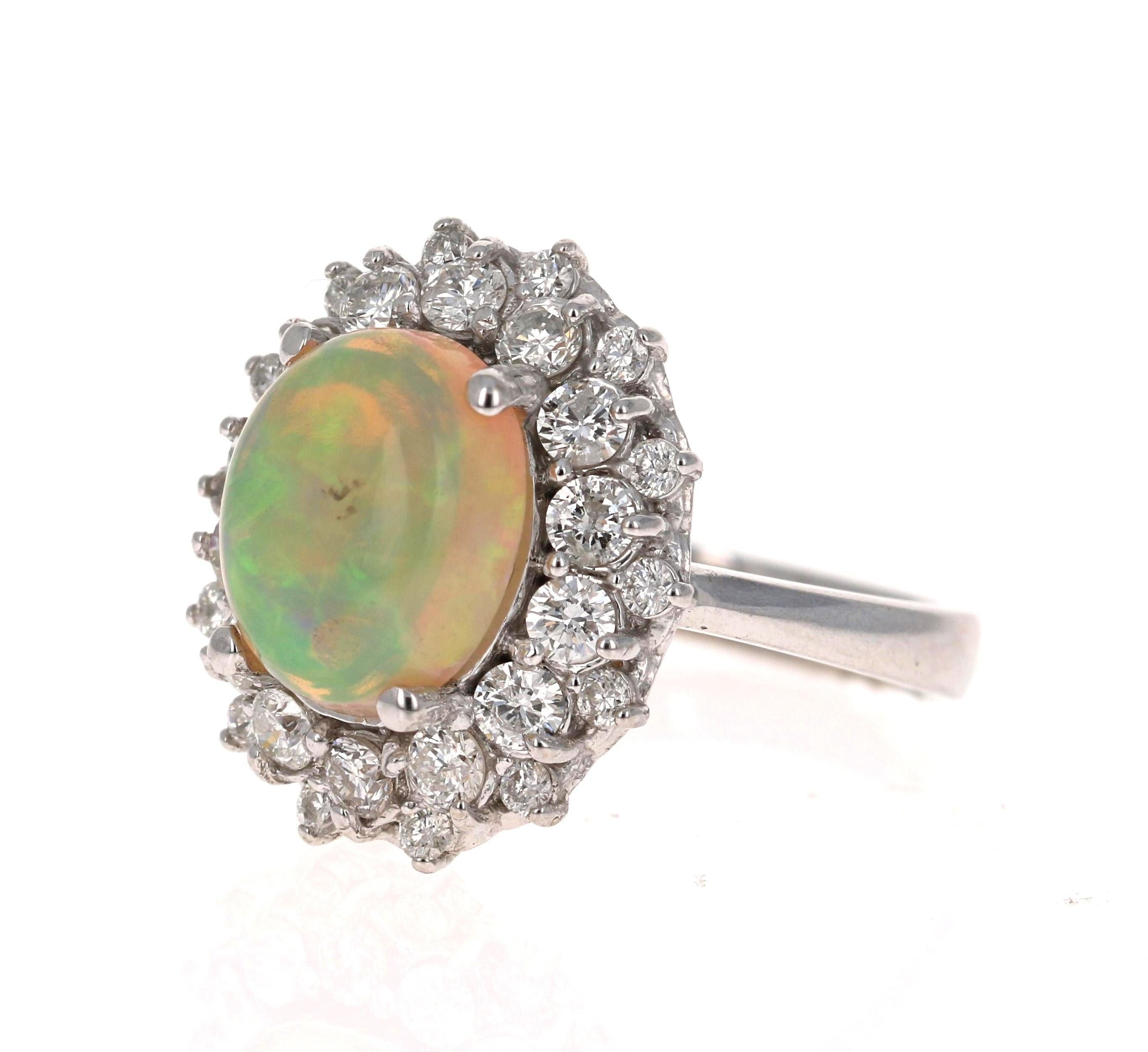 This ring has a gorgeous Oval Cut Opal in the center that weighs 2.72 Carats and has a clusterof 28 Round Cut Diamonds that weigh 1.32 Carats. The total carat weight of the ring is 4.04 Carats. 

The measurements of the Opal are 11mm x 13mm.

The