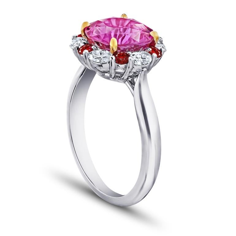4.04 carat round natural no heat pink sapphire surrounded with six oval diamonds .56 carats and six round rubies weighing .36 carats set in platinum and 18k yellow gold ring