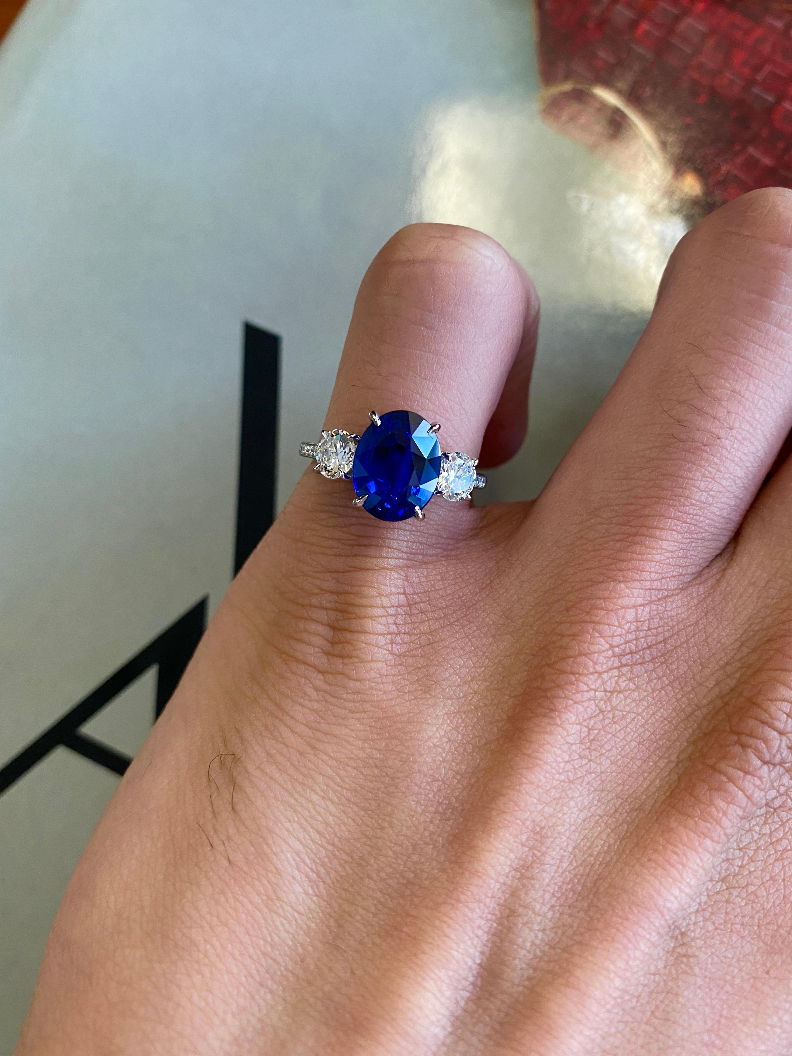 This ring features an absolutely gorgeous 4.04 carat gem oval Sapphire, certified by C. Dunaigre of Switzerland. The stone is a very rich royal blue, not overly dark, with tremendous fire and sparkle. Its origin is Ceylon (Sri Lanka) and is only