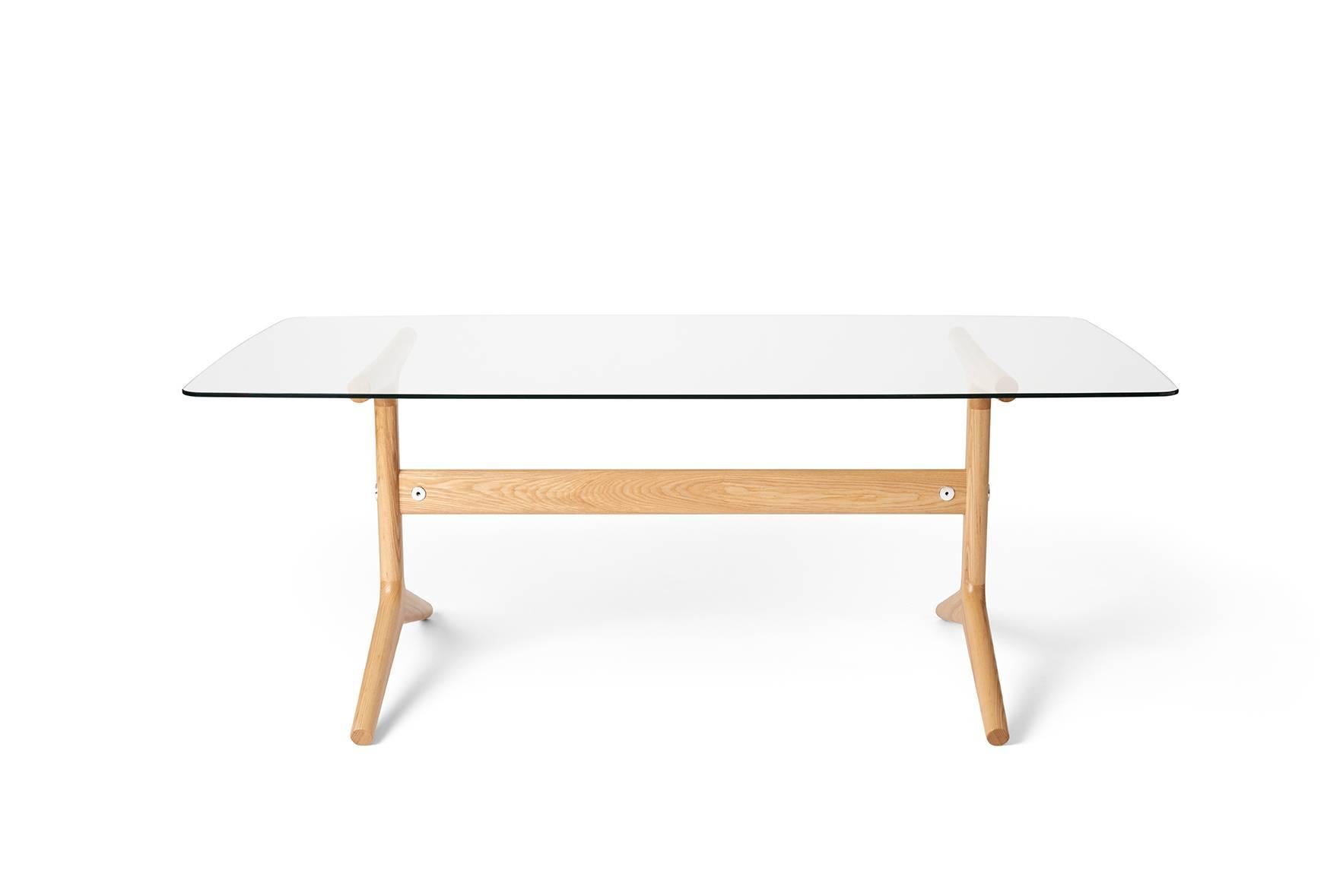 The 404 linear table has a hand formed base composed of North American Ash with mirror-polished aluminum fittings. Its linear boat-shaped top in tempered glass comfortably seats six. Well suited as a dining or writing table. 

Measures: H 29