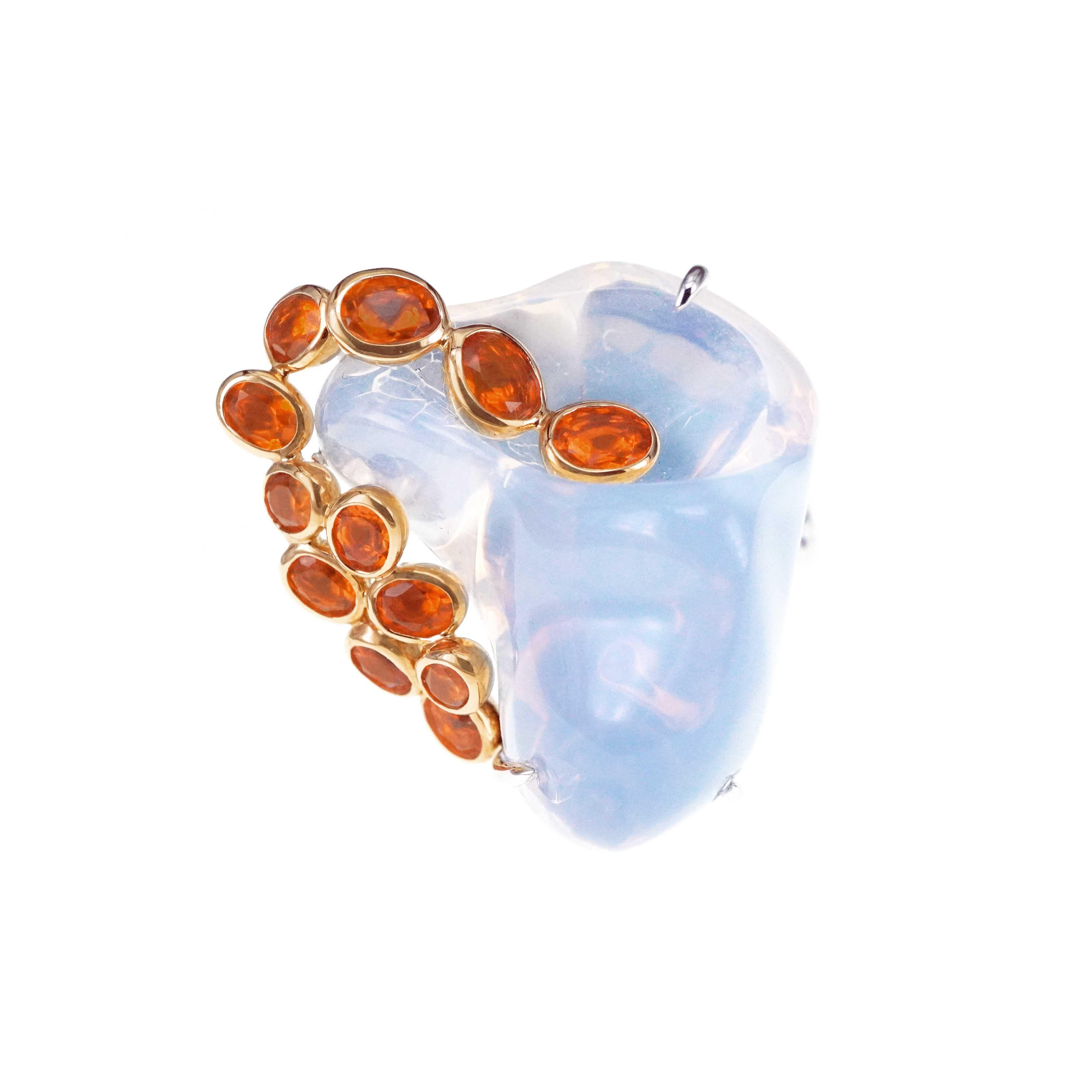 A 40.44 carat huge Mexican opal is set along with 1.64 carat of fiery orange Mexican fire opal and 0.29 carat of white round brilliant diamond.  The ring is one of a kind as the 40.44 carat Mexican opal shape is unique and difficult to find another