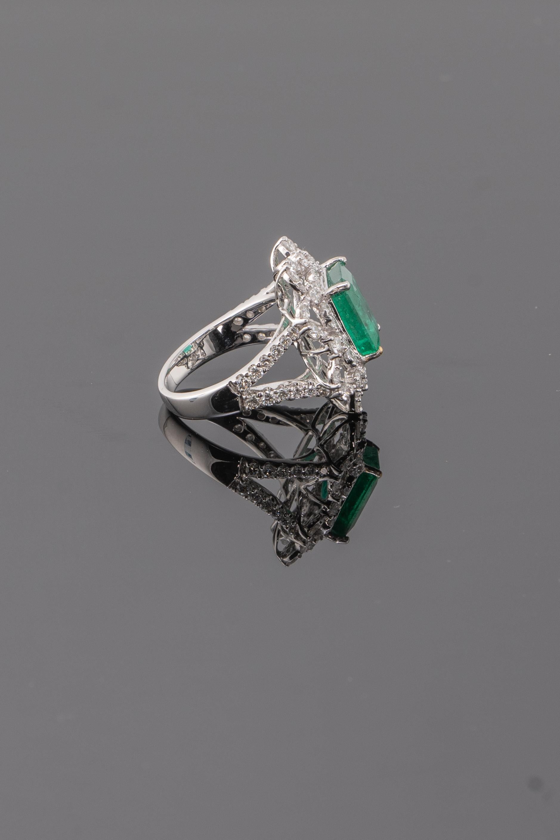 Make a statement with this beautiful, natural 4.05 carat Zambian Emerald and 1.78 carat White Diamond Cocktail Ring. The center stone is transparent with very few naturally occuring inclusions, and great lustre. 
Currently sized at US 6, can be