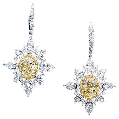 Novel Collection showcasing a stunning pair of Art Deco Style Drop Diamond Earrings, with center pair of oval-cut, fancy light yellow diamonds weighing a total weight of 4.05 Carat, GIA certified as 
IF-VS2 in clarity. Surrounded with 48 round