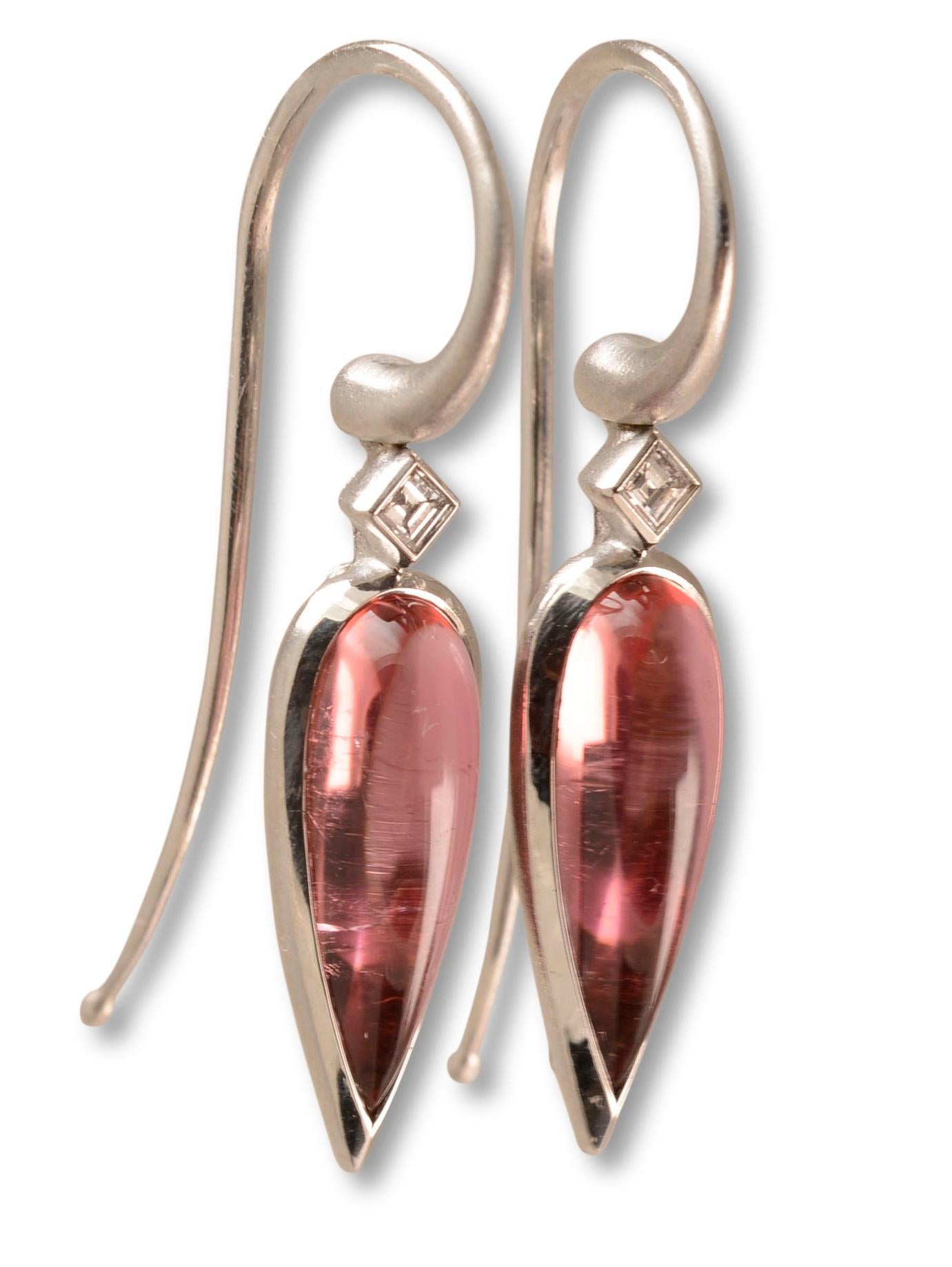 Simple, elegant contemporary design and luscious coloured gemstones combine to create these signature Nicky Burles drop earrings. Two elongated pear shaped pink tourmalines totalling 4.05 carats feature in a fine 18 karat white gold bezel setting,