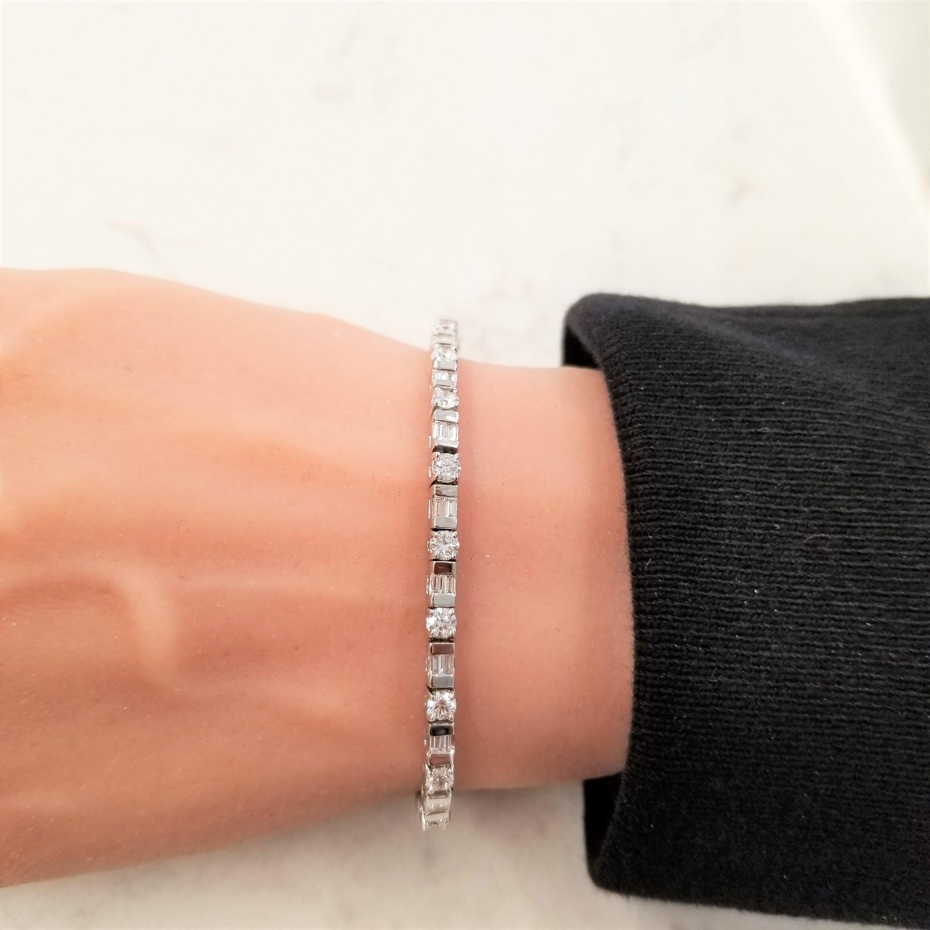 This bracelet is brimming with brilliance and contrast! It features fully faceted rounds and contrasting step-cut baguette diamonds that wrap around the wrist in an alternating fashion. There are 21 round diamonds and 42 baguette diamonds hand-set