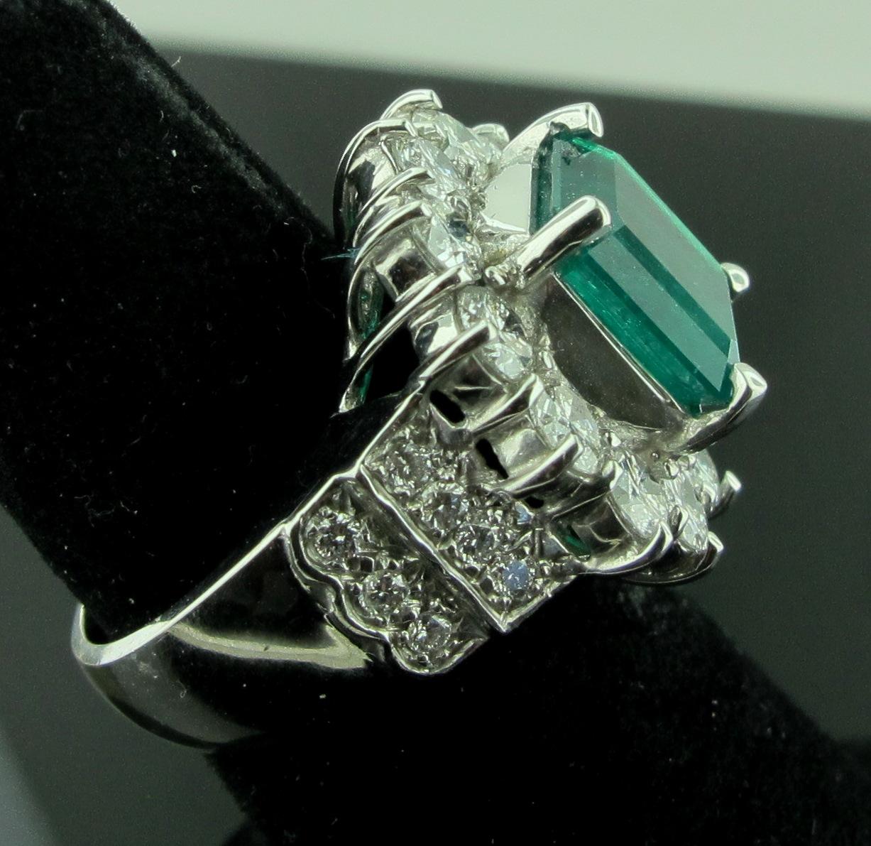Set in 18 karat white gold is a 4.06 emerald cut Emerald, surrounded by 2.22 carats of round brilliant diamonds.  The diamonds are I-J color, SI clarity. Gold weight is 13 grams.  Ring size is 6.5.