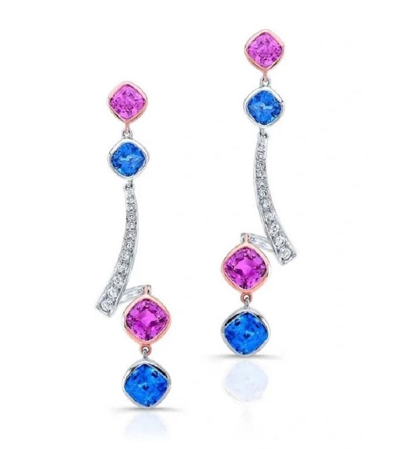 Beautiful and modern but soft dangle earrings featuring a total weight of 4.06 carats of natural blue sapphires, 3.53 carats of natural pink sapphires and .36 carats of diamonds set in 18 karat white and rose gold. Post back. 
Length: approximately