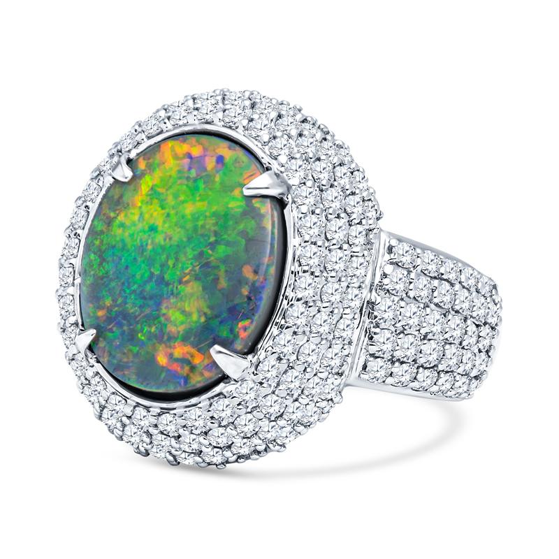 This beautiful ring features a 4.07 carat oval lightening ridge black opal displaying a phenomenal red, orange, yellow, blue, green play of color. The ring  is set in 18 karat white gold and encrusted with pave set diamonds with a total carat weight