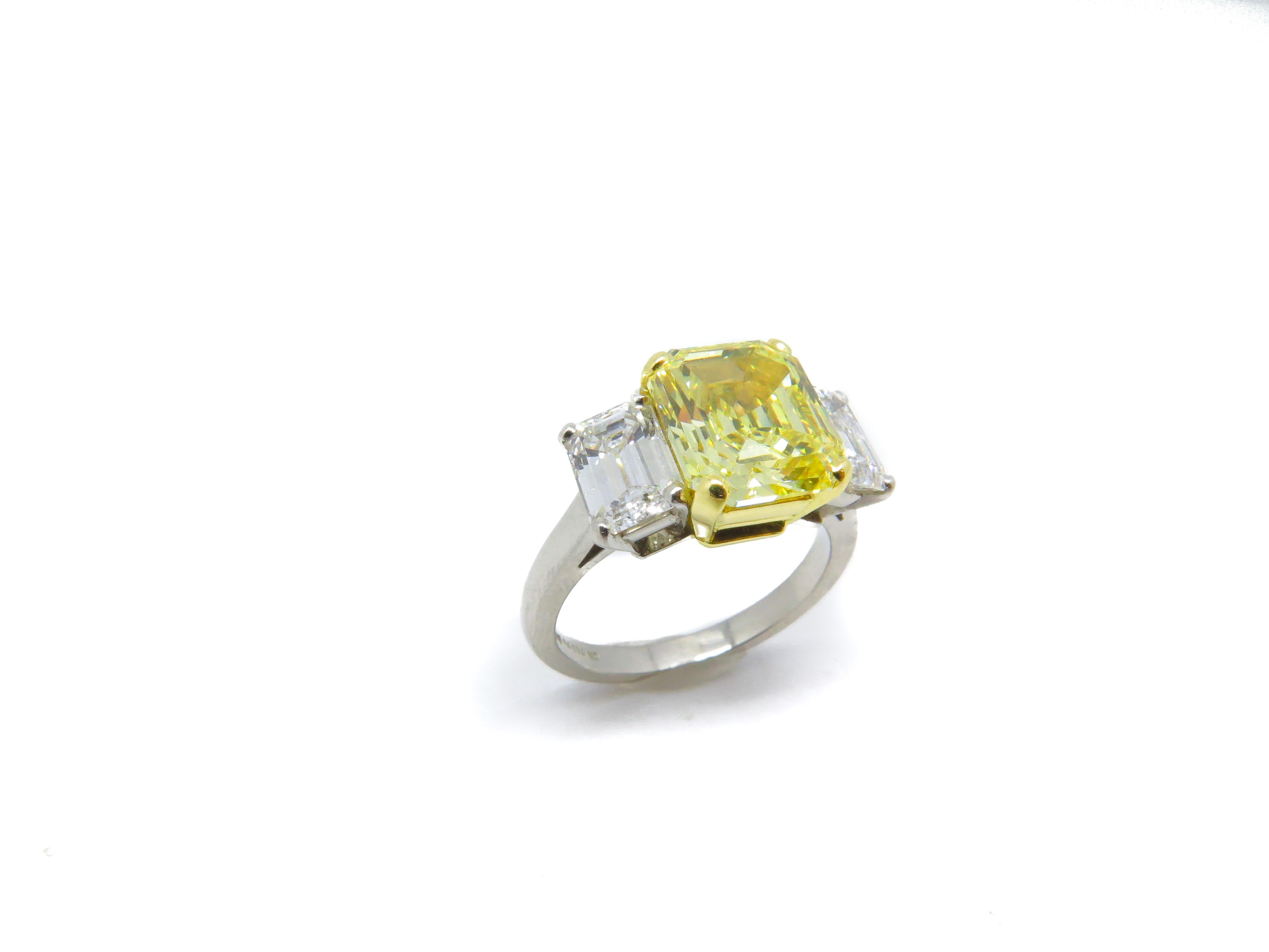 Women's 4.07 Carat Fancy Vivid Emerald Cut Yellow Diamond Three Stone Engagement Ring For Sale