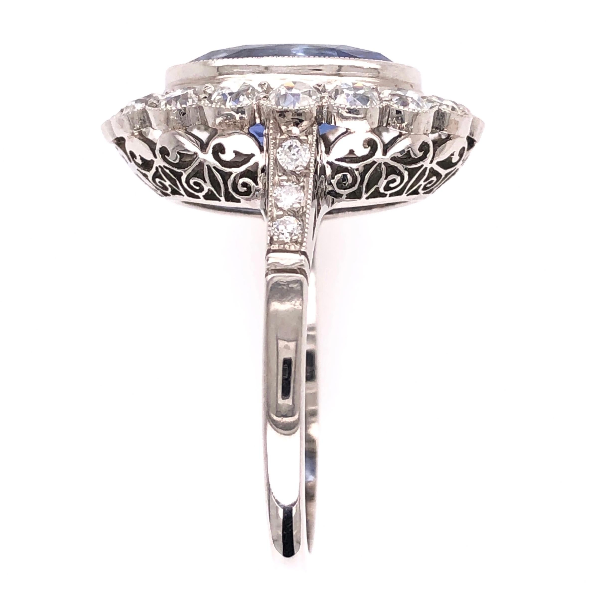 Beautiful, Elegant & finely detailed Art Deco Style Platinum Halo Ring, center securely nestled with a NO HEAT Blue Sapphire, weighing approx. 4.07 Carats; surrounded by Diamonds and small Diamonds enhancing the shank; approx. total weight of
