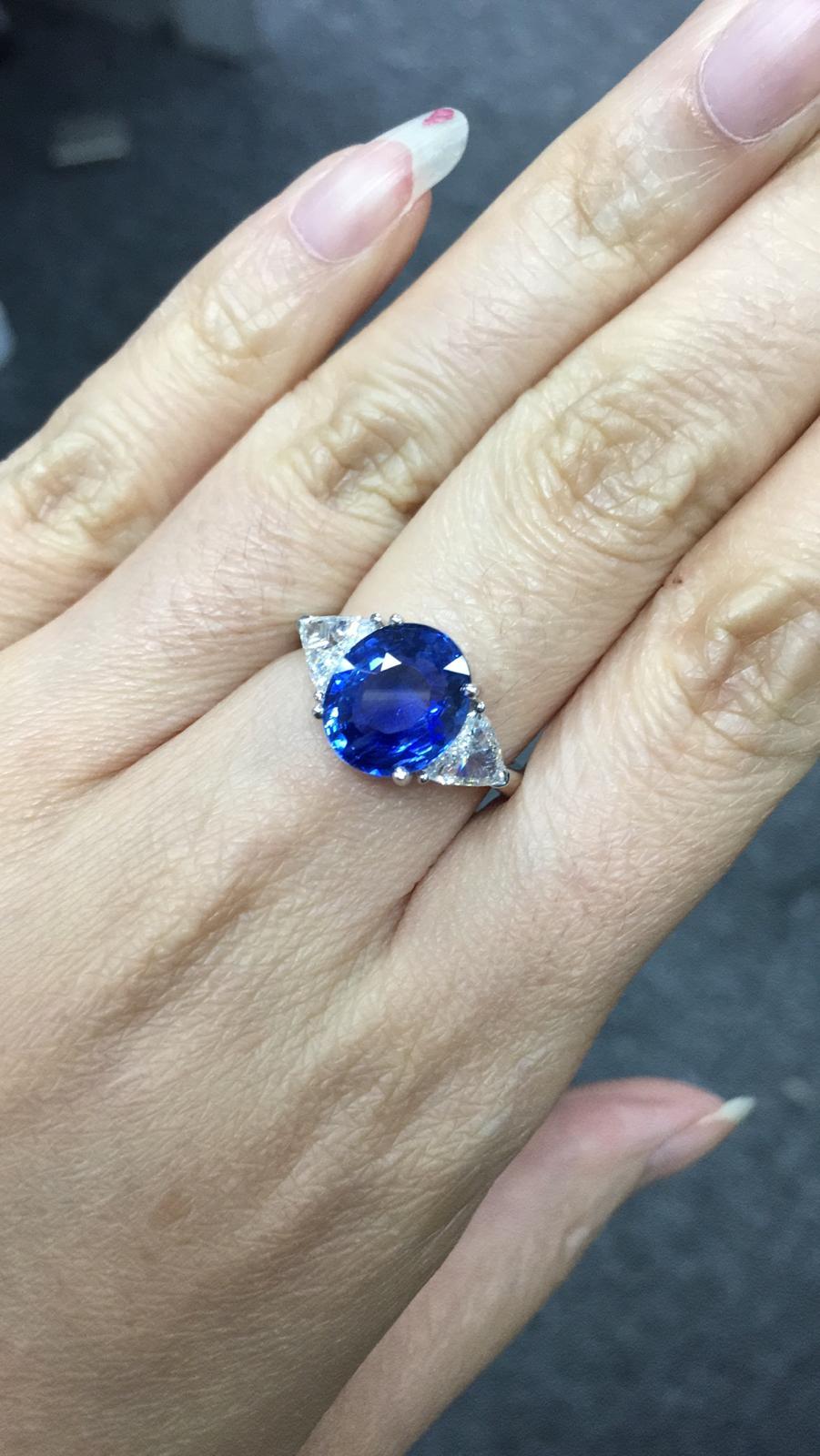 Primary Stone: Sapphire ( Sri Lanka )
Shape : Oval Cut
Sapphire Weight: 4.07 Carats (1 Sapphire)
Measurements Sapphire: 10.64 mm x 9.01 mm x 4.73 mm
Color: Vivid Blue
Accent Stones: Genuine Diamond
Shape Or Cut Diamond: 2 Triangular Cut