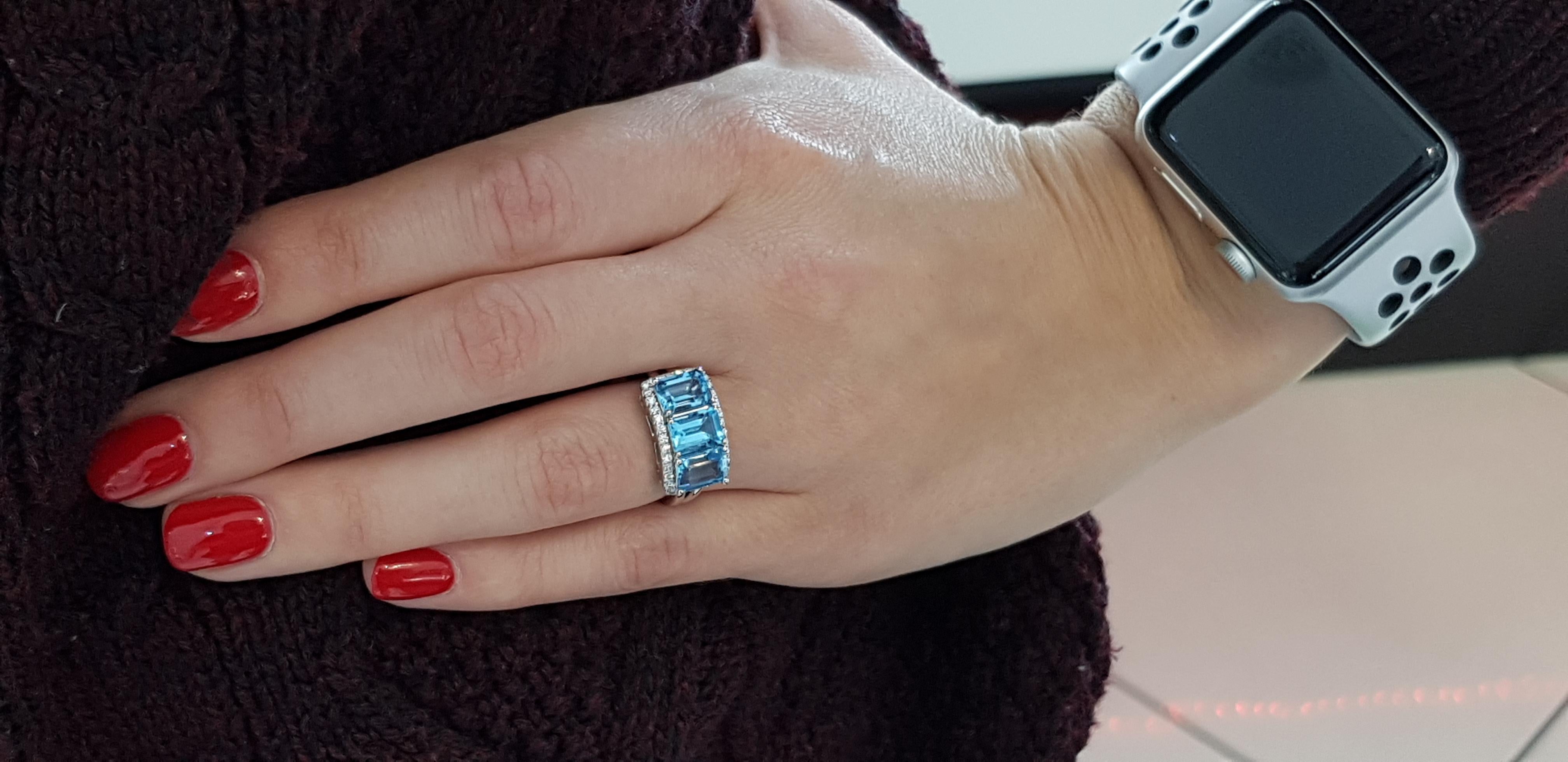 Modern 4.08 Carat Emerald Cut Blue Topaz Diamond Halo 18 KT White Gold Engagement Ring For Sale