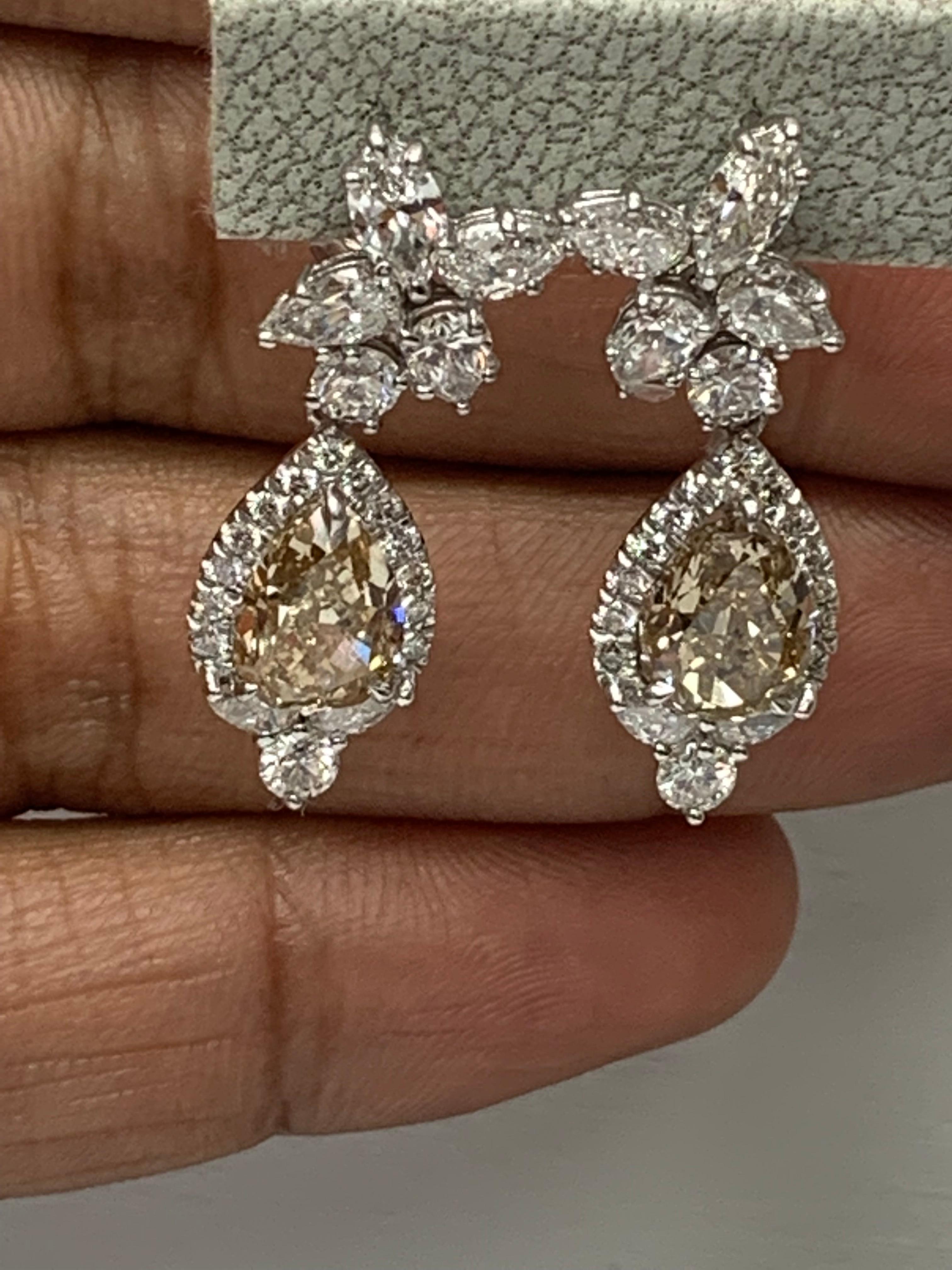 A beautiful and chic pair of drop earrings showcasing a cluster of brilliant mixed-cut diamonds, and pear-shaped brilliant brown diamonds set in an intricate and stylish design.  10 Mixed cut Diamonds weigh 1.91 carats in total. 2 Brown diamonds