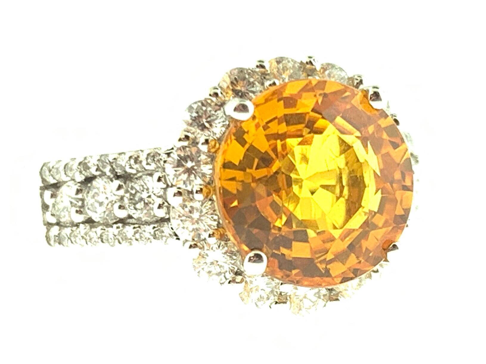 This stunning cocktail ring features a beautiful 4.08 Carat Round Yellow Sapphire with a Diamond Halo. The Sapphire sits on a Diamond Shank and is set in 18k White Gold. Total Diamond Weight = 0.86 Carats. Ring Size is 6 1/4.