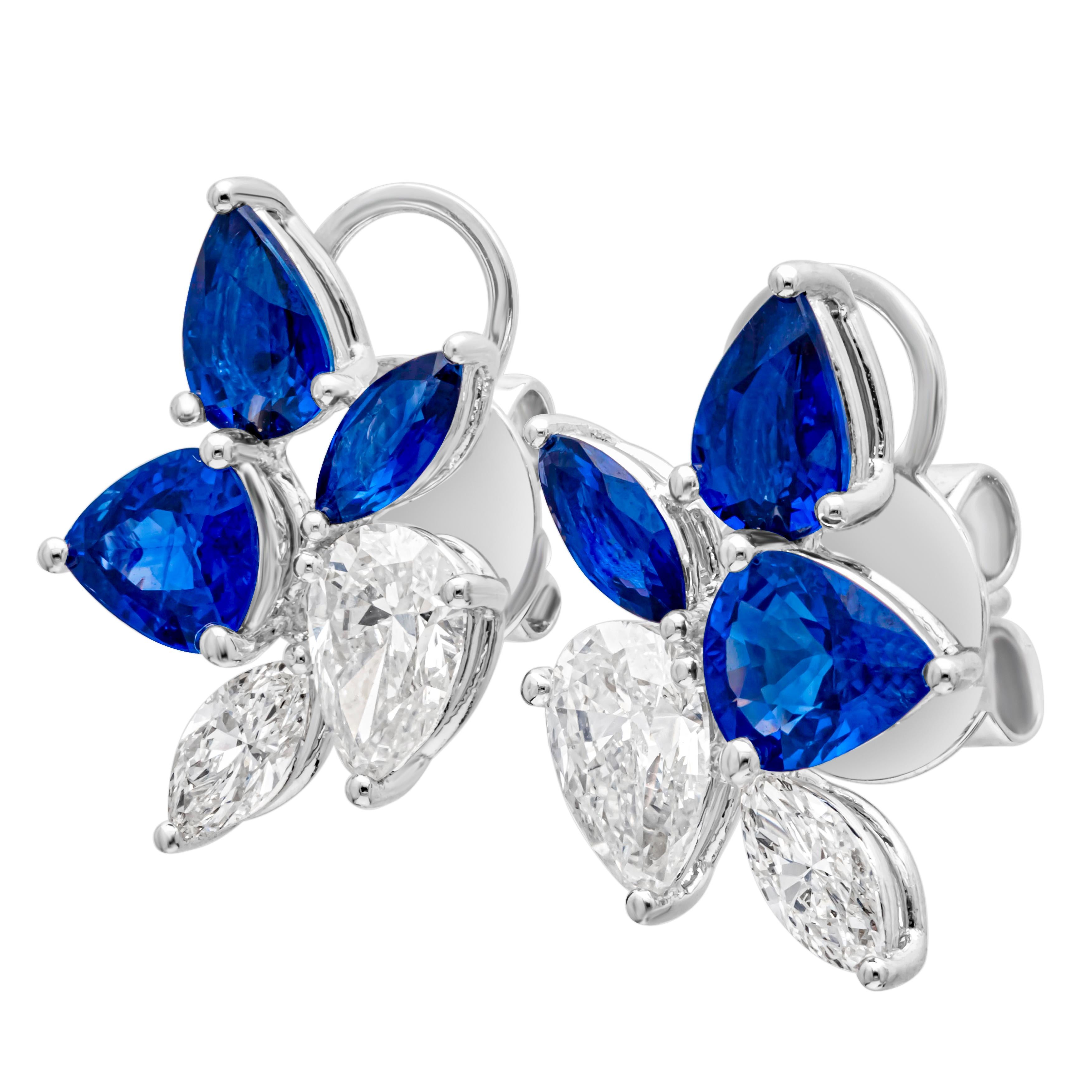 An exquisite and fashionable pair of stud earrings showcasing a cluster of pear shape and marquise cut color-rich blue sapphires and diamonds, set in a beautiful floral-motif cluster design and prong setting. Blue sapphires weigh 2.73 carats total,