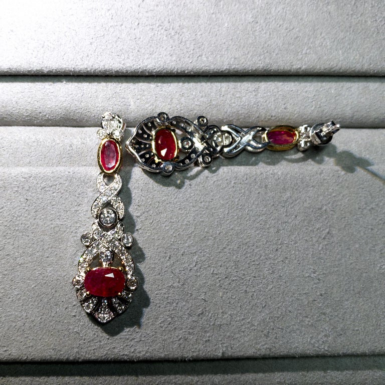 4.08ct Burmese unheated Pigeon Blood Ruby and Diamond Earring in 18k Gold 

Total Ruby weight is 4.08ct
Total Natural Diamond Weight is 1.402ct, The Colour of the Diamond is Approximately E/F with VS Clarity
This Pair of Earring Comes of a