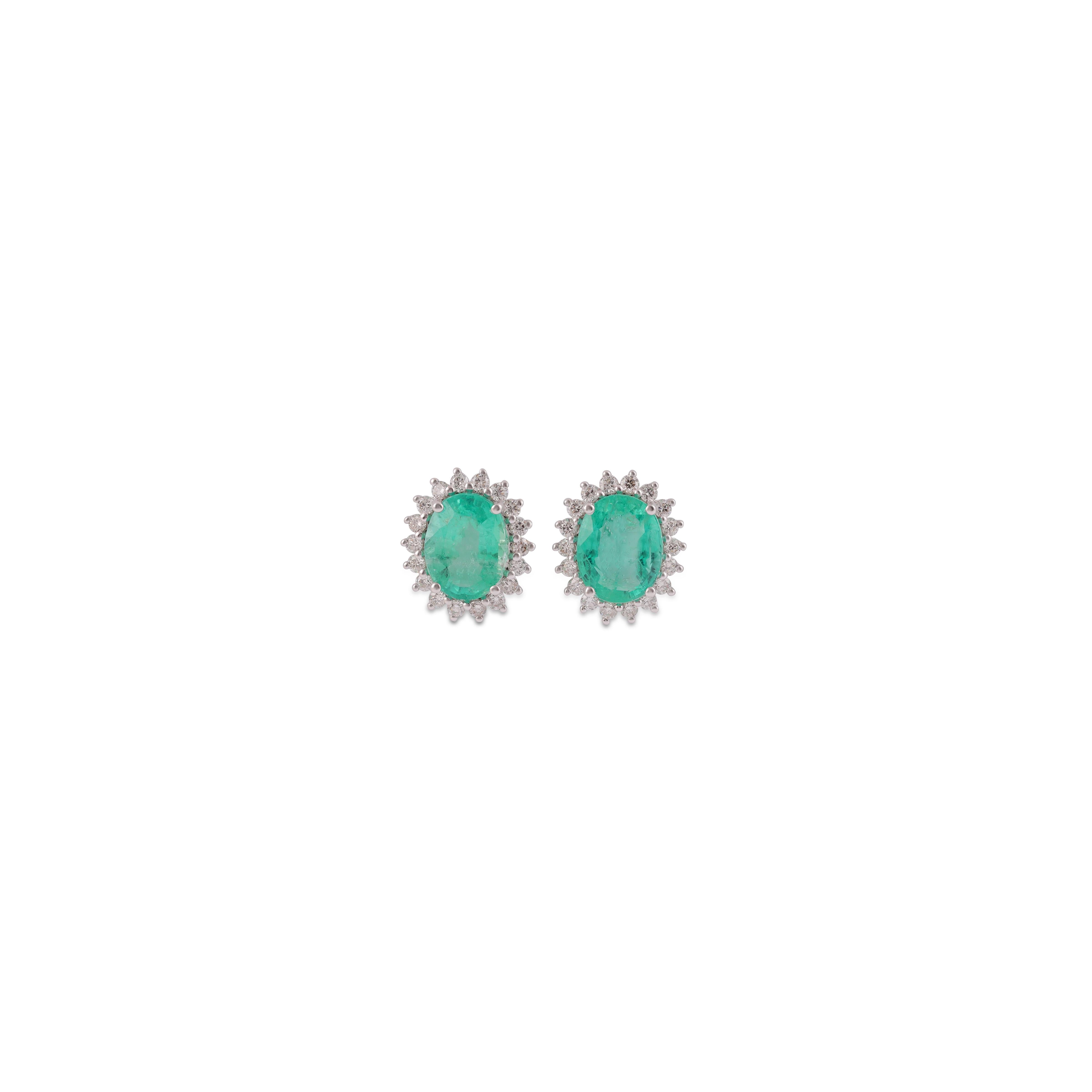 This is an elegant emerald & diamond Earring studded in 18k White gold with 2 piece of oval Cut  shaped Zambian emerald weight 4.09 carat which is surrounded by 36 pieces of round shaped diamonds weight 0.51 carat, this entire Earring studded in 18k
