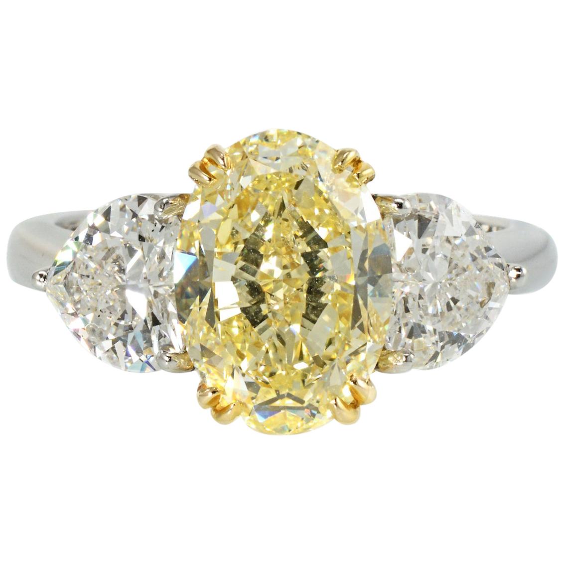 4.09 Carat Oval Cut Fancy Yellow Three-Stone Diamond Engagement Ring For Sale