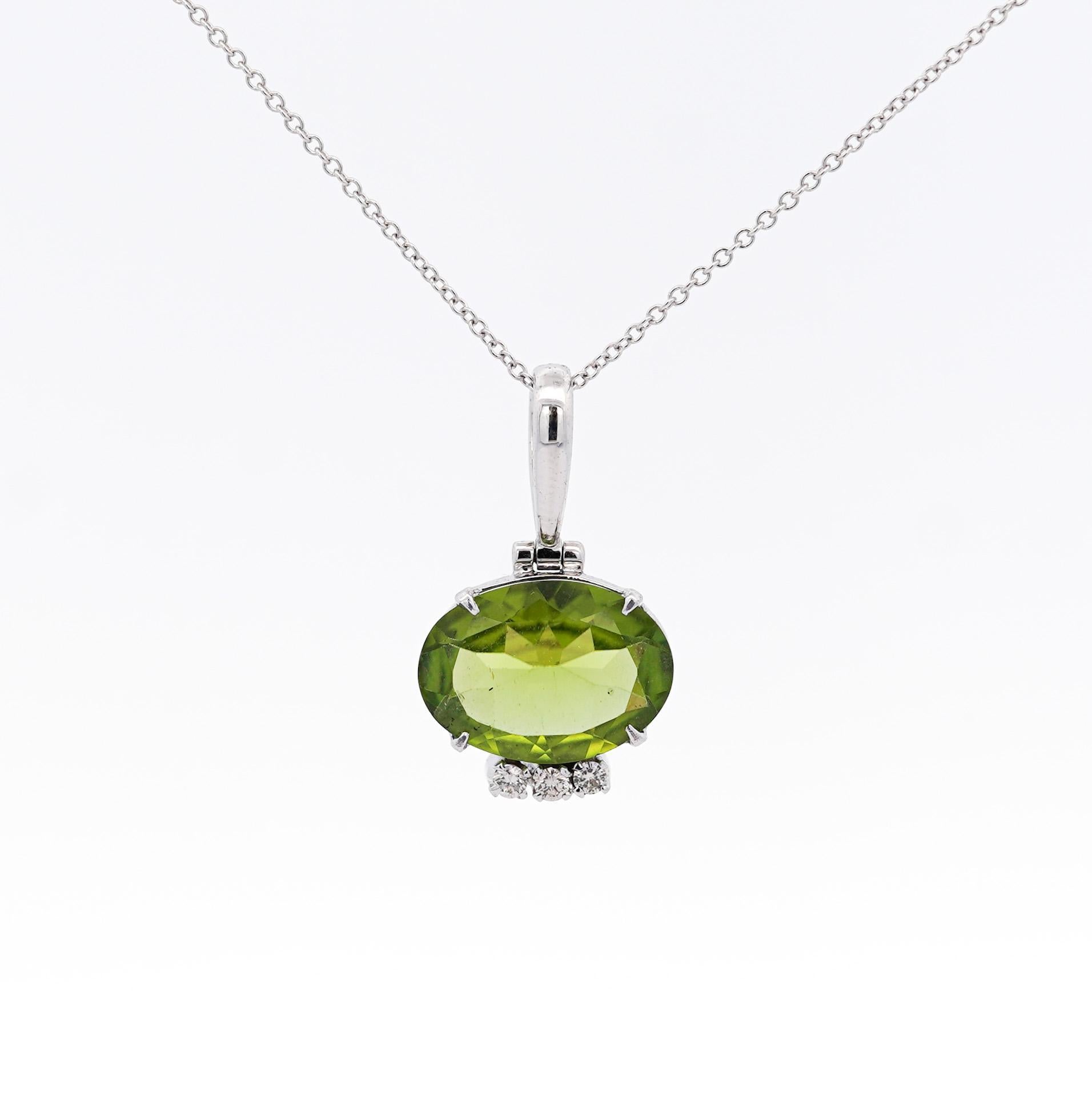 4.09 Carat Peridot Pendant Necklace in 18K White Gold Cable Chain. Statement pendant necklace with an astonishing oval cut, 4-prong set peridot stone dangling from the chain in a vibrant yellowish-green color and excellent transparency. Would pair