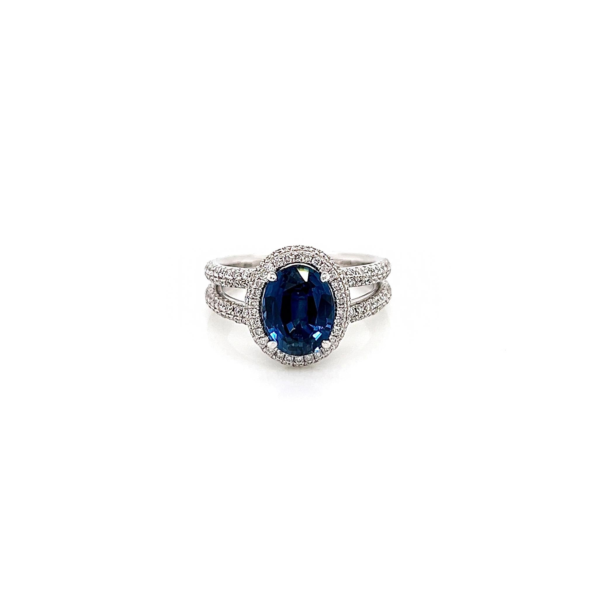 4.0 Total Carat Sapphire and Diamond Halo Pave-Set Ladies Ring

-Metal Type: 18K White Gold, Split Shank 
-2.95 Carat Oval Cut Natural Blue Sapphire 
-1.05 Carat Round Natural Diamonds. F-G Color, VS-SI Clarity 
-Size 6.25
