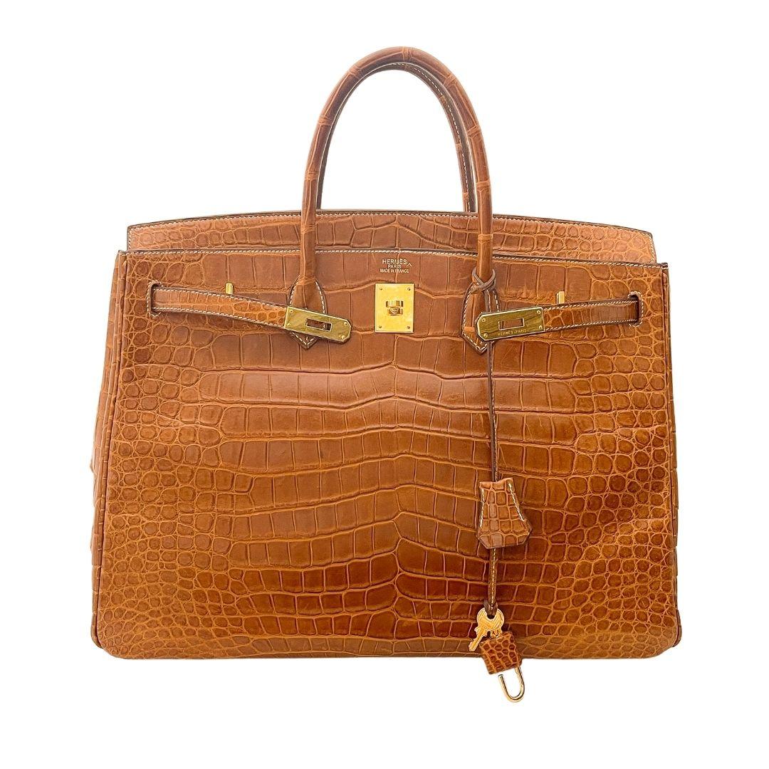 More than just a purse, Hermes Birkin bags are coveted items that grow in value. This would be great for your collection and is an investment. 

This iconic handbag is 40cm with gold hardware. The cognac color crocodile leather is luxurious and