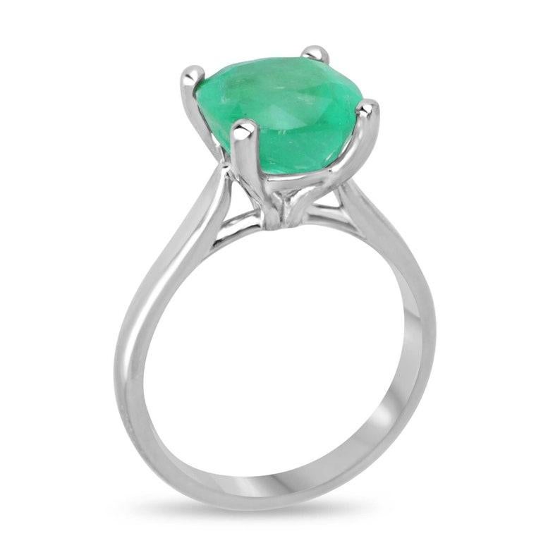 Introducing our captivating Solitaire Cushion Cut Emerald Ring, featuring a breathtaking 4.0-carat emerald from Colombia. This emerald's vibrant green hue comes alive with an unmistakable intensity, complemented by its semi-transparent clarity,