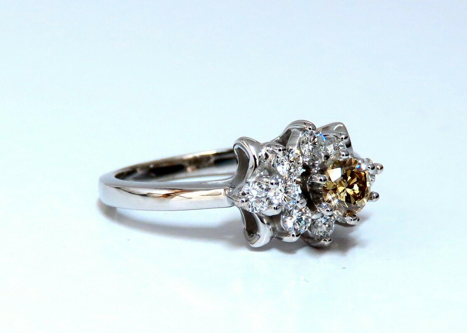 Halo Raised Solitaire

.40ct Natural Fancy Yellow Brown Diamond. 

Vs-2 clarity.

.50ct. Side natural round diamonds:

Vs-2 Clarity G-color.

Ring measures: 

 10mm wide

9.3mm Depth

Size 7.5

14kt. white gold.

4.4 Grams

Resizing is possible,