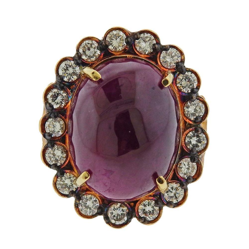 Impressive 18k yellow gold cocktail ring, set with an approx. 40cts ruby cabochon (measuring approx. 21.3 x 16.5 x 10.5mm) ,  diamonds approx. 1.90ctw. ring size - 8, ring top is 30mm x 25mm. Tested 18k. Weight - 25.9 grams.R-02713