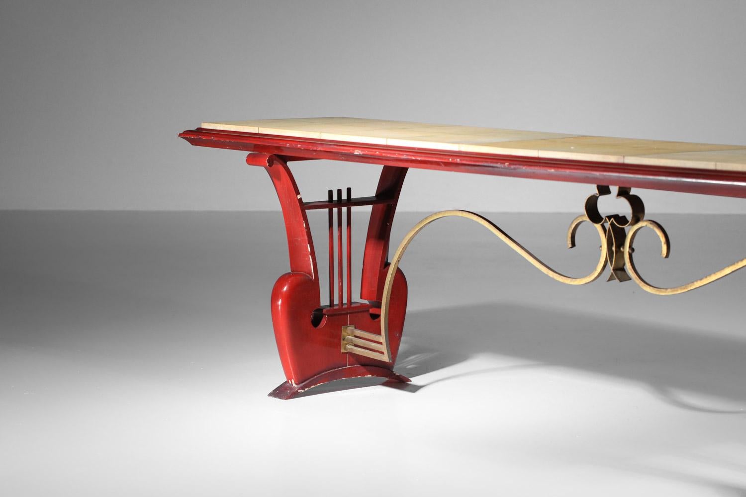 Bench or coffee table from the 40's and 50's in red lacquered wood (original paint) and parchment. High quality craftsmanship and very original with harp-shaped legs. Nice vintage condition, with traces of time and use, but also chips on the lacquer