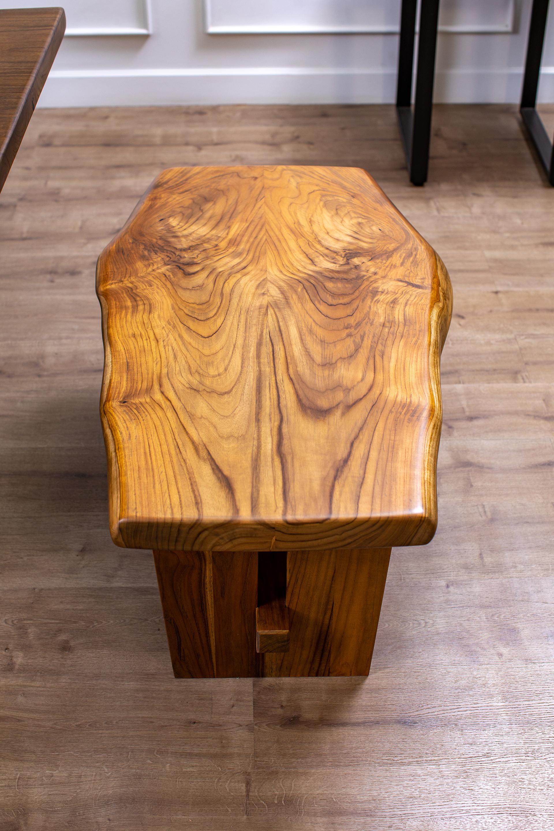 A one-of-a-kind piece, this book-matched solid teak bench is a stunning addition to any home. Two 2