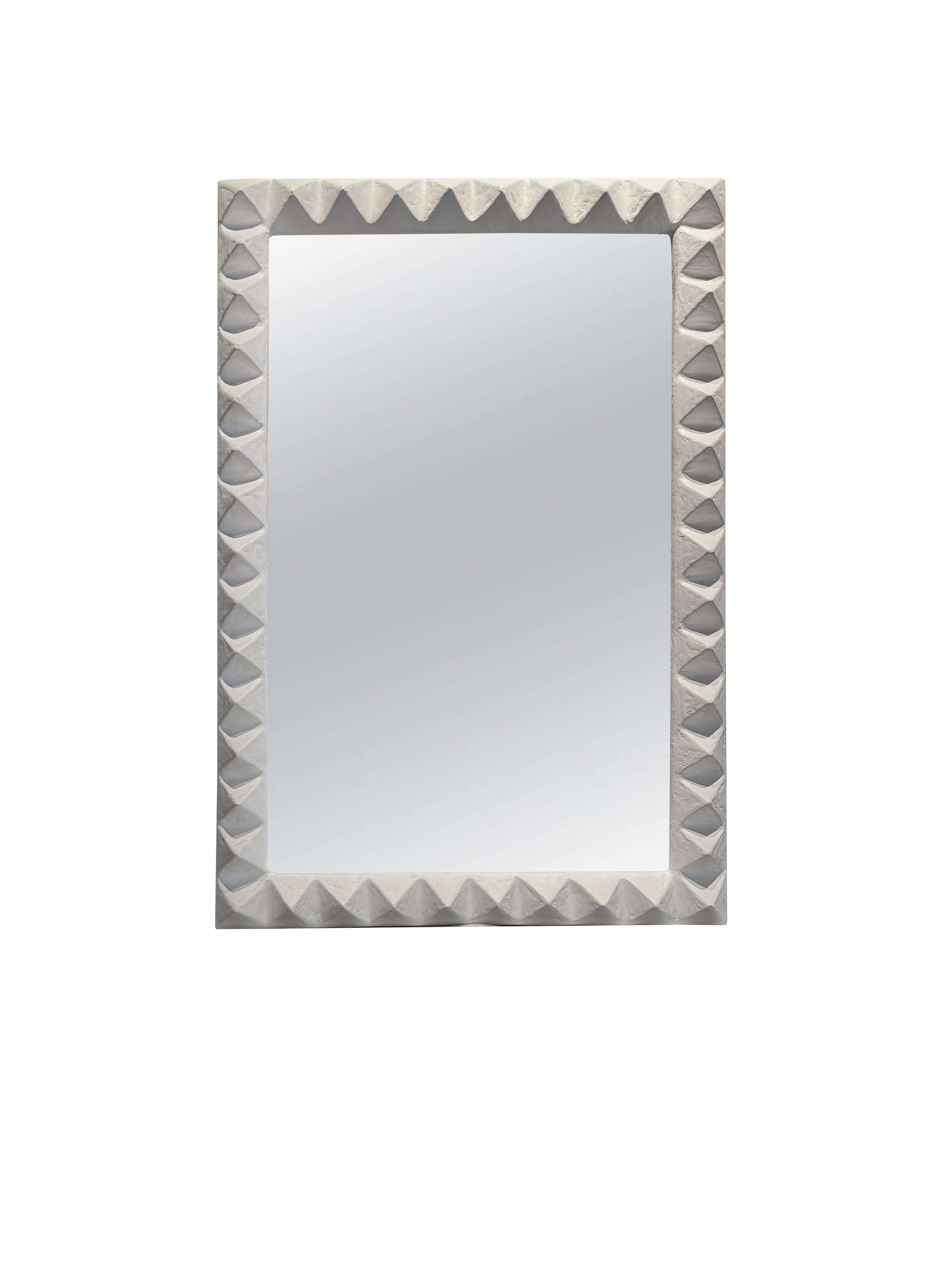Introducing the Le Stud Mirror, a bold, architectural wall mirror that celebrates texture, form, and irreverent style. 

This sculptural piece redefines the traditional mirror with its robust, hand-carved frame and rhythmic geometry. Handcrafted