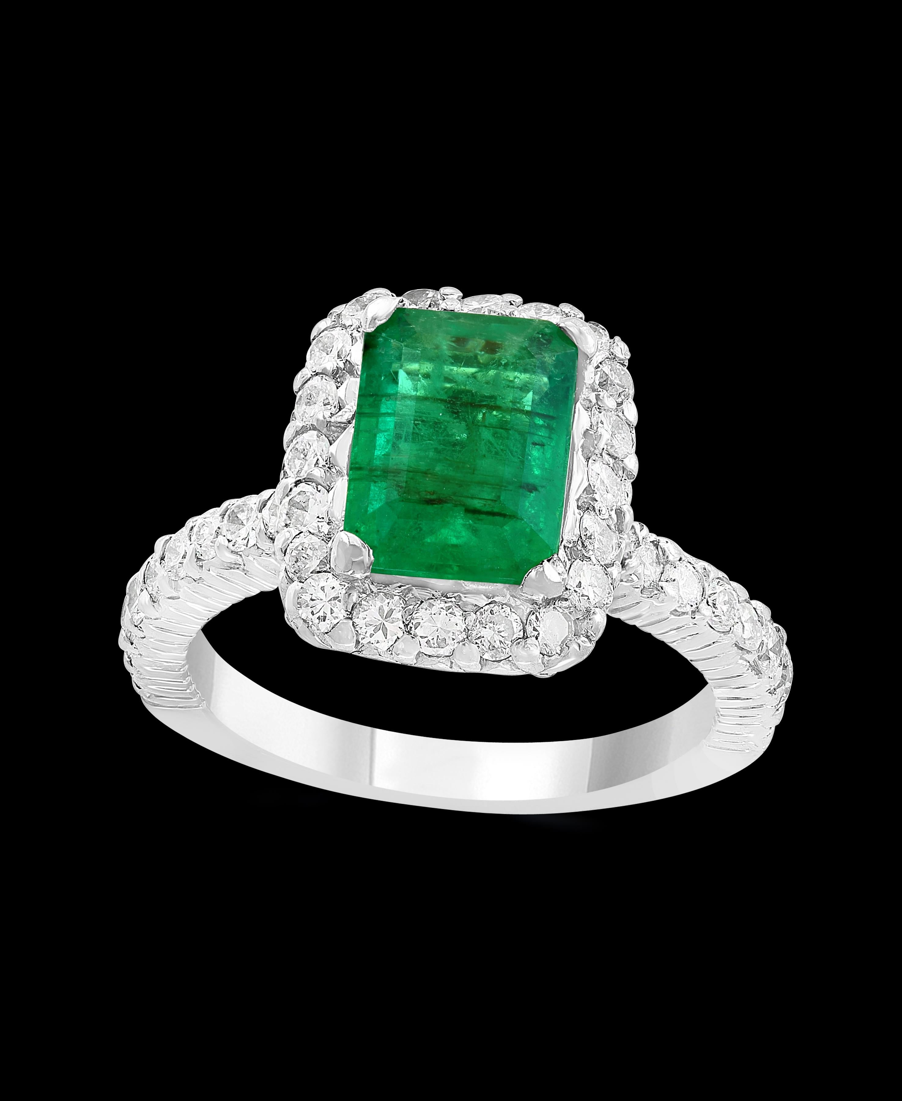 A classic, Cocktail ring 
4.1 Carat Colombian Emerald and Diamond Ring, Estate.
Platinum 10.5 gm
Diamonds: approximate 1.8 Carat 
Emerald: 4.1 ct
Origin : Colombia 
Color: Deep Green, Transparent extreme Fine Color Quality
One of our finest