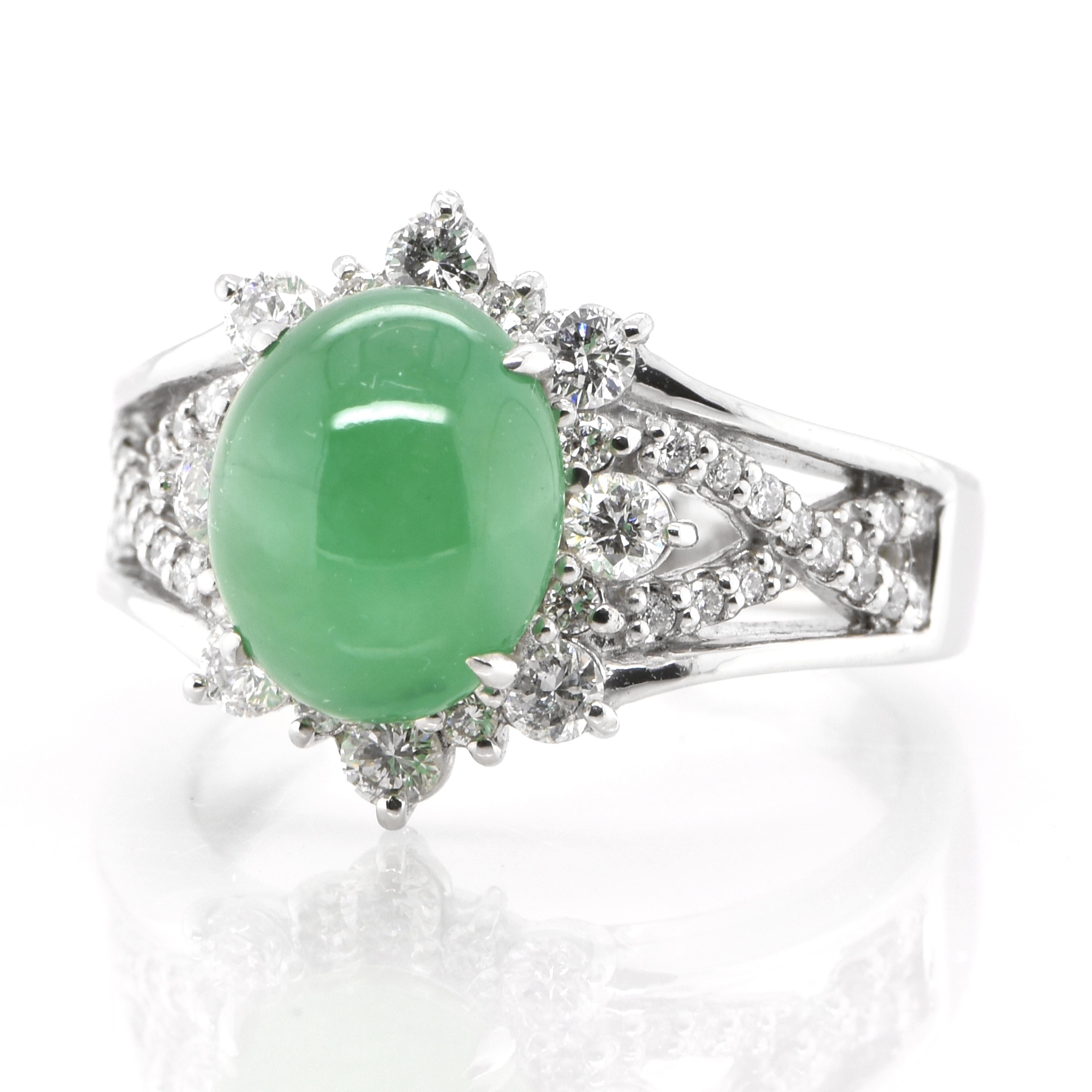 A beautiful Cocktail Ring featuring a 4.10 Carat Natural Apple Green Jadeite and 0.58 Carats of Diamond Accents set in Platinum. Jade has been cherished for millennia. Its nature is pure and enduring, yet sensuous and luxurious. Jadeite’s