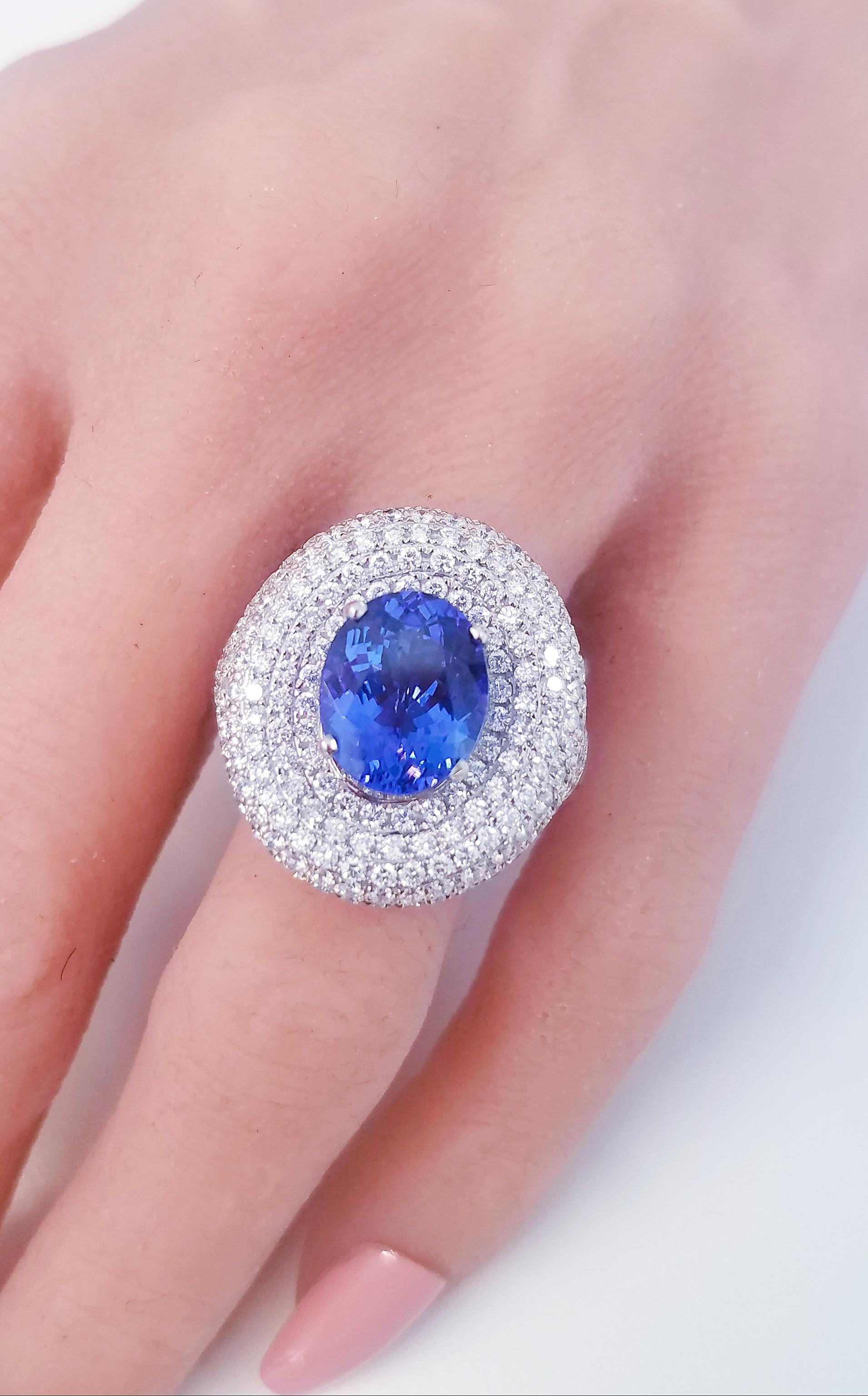 This lavish brightly polished 18 karat white gold smooth oval shaped cocktail ring presents one hand selected fine quality oval cut tanzanite prong set in the center, originating from Tanzania with a beautiful color saturation. A total of 5.16