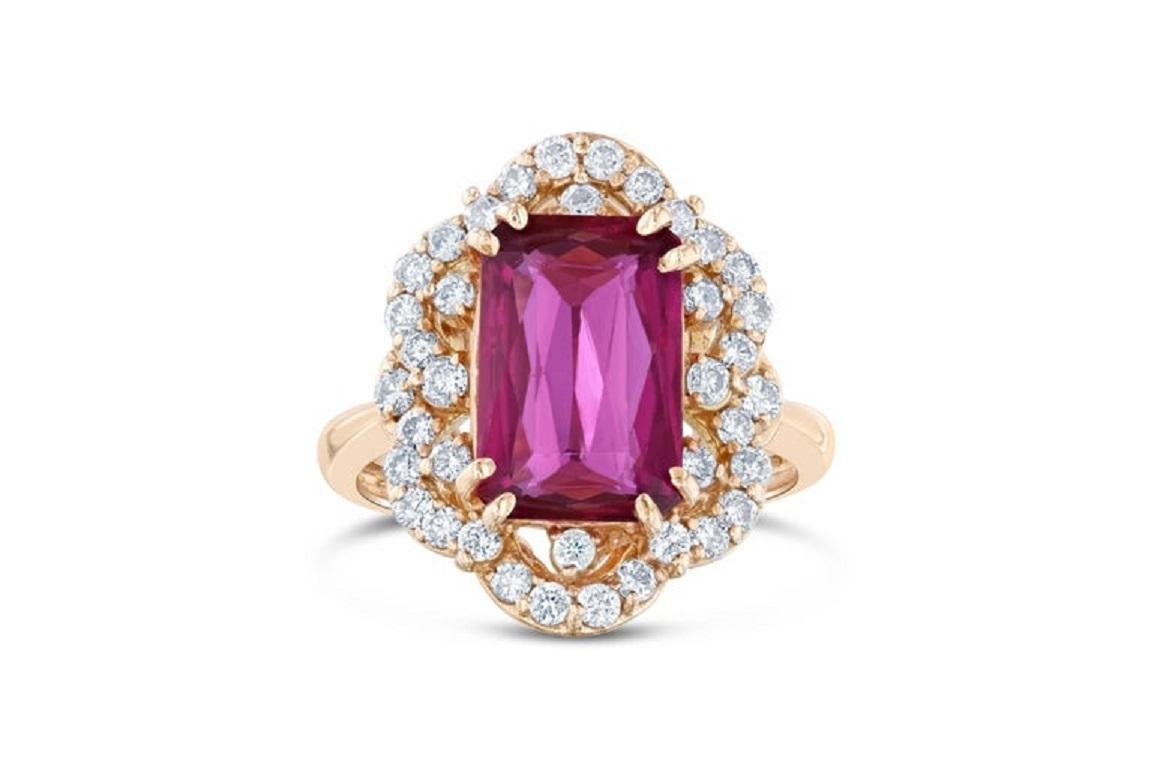 Wow! Beautiful and Blazing - Hot Pink Tourmaline Diamond Ring!

This exquisitely unique ring has a vintage look and has a striking emerald cut Pink Tourmaline weighing 3.36 Carats. There are 38 Round Cut Diamonds weighing 0.74 Carats. The total