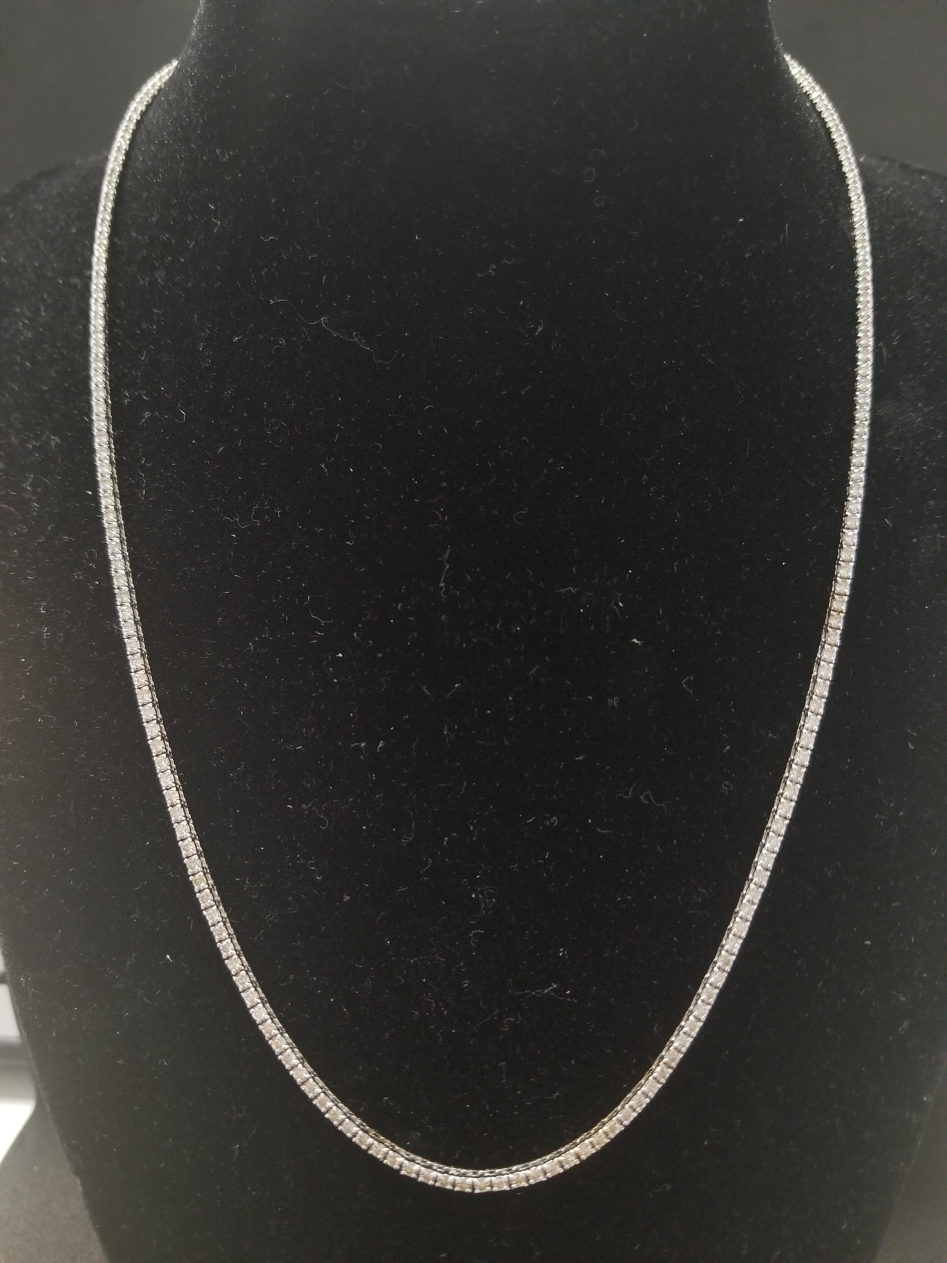 Stunning 14 Karat White Gold Round Brilliant Cut Diamond Tennis Necklace set on 4 prong setting. The total diamond weight is 4.10 carats. The closure is an insert clasp with safety clasp. Length is 18 inches.