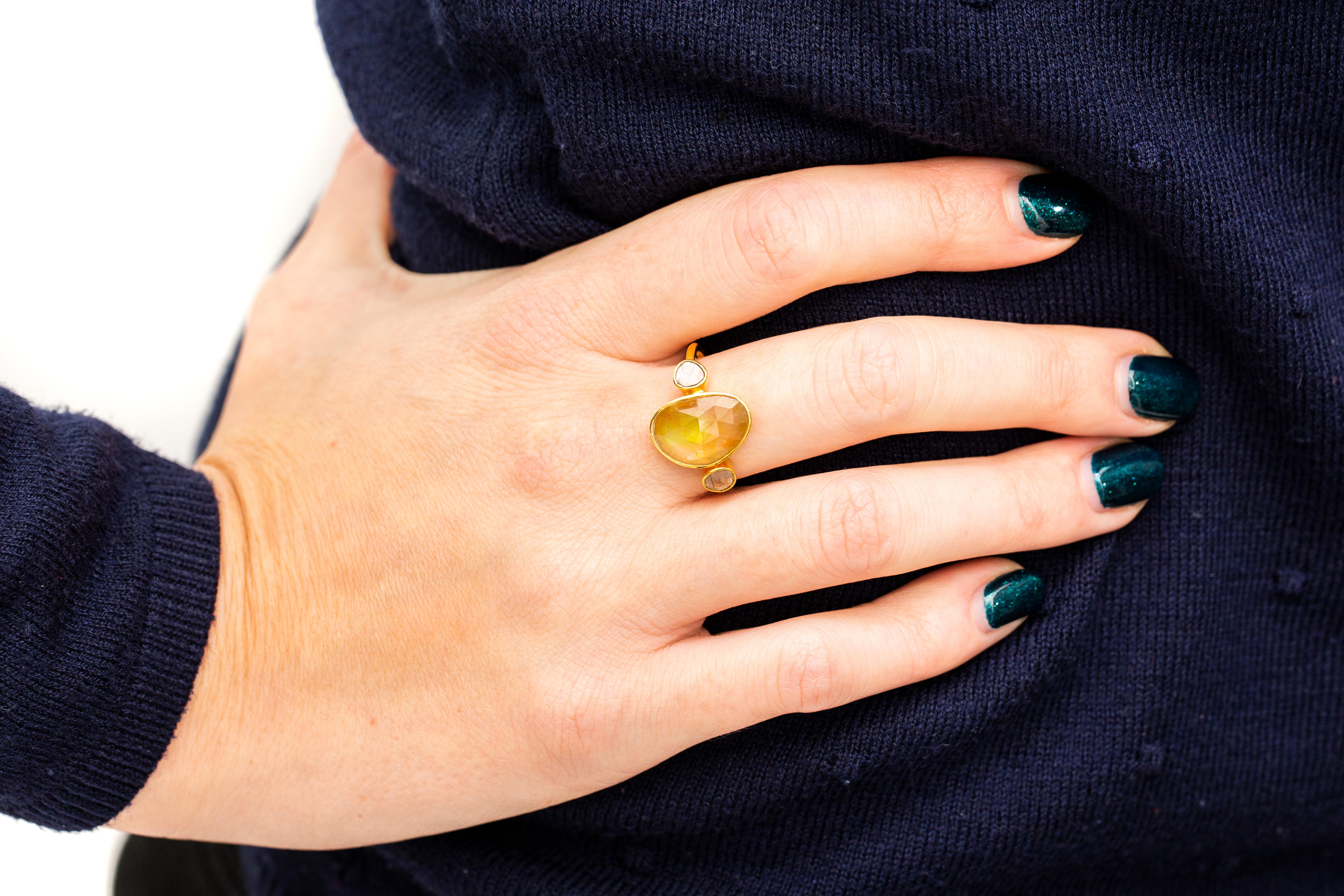 This Gorgeous 3.95 Carat Yellow Sapphire ring features 0.15 Carat in two Diamond slices one on each side set in 18 Karat Yellow Gold. This unique Yellow Sapphire and Diamond 3 stone Rose Cut ring is perfect for any occasion night or day. Each piece