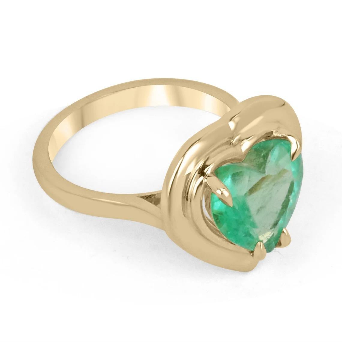 An edgy solitaire heart one of a kind emerald statement ring. This fabulous piece features a natural heart-cut Colombian emerald that showcases a medium vivid green color, with excellent to very good luster and clarity. This Colombian emerald