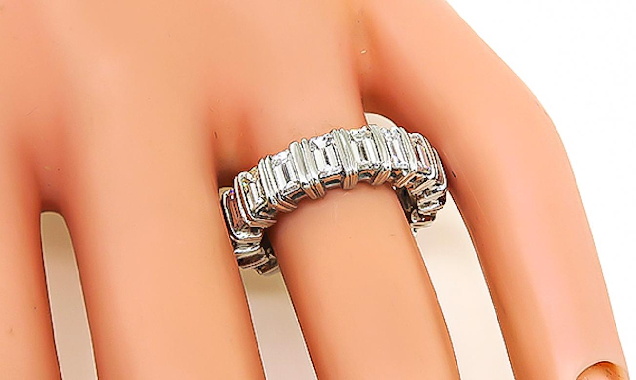 This is a beautiful platinum eternity wedding band. The band is set with sparkling emerald cut diamonds that weigh 4.10ct. The color of these diamonds is G-H with VS1 clarity. The band measures 6mm in width and weighs 12 grams. The band is size 6