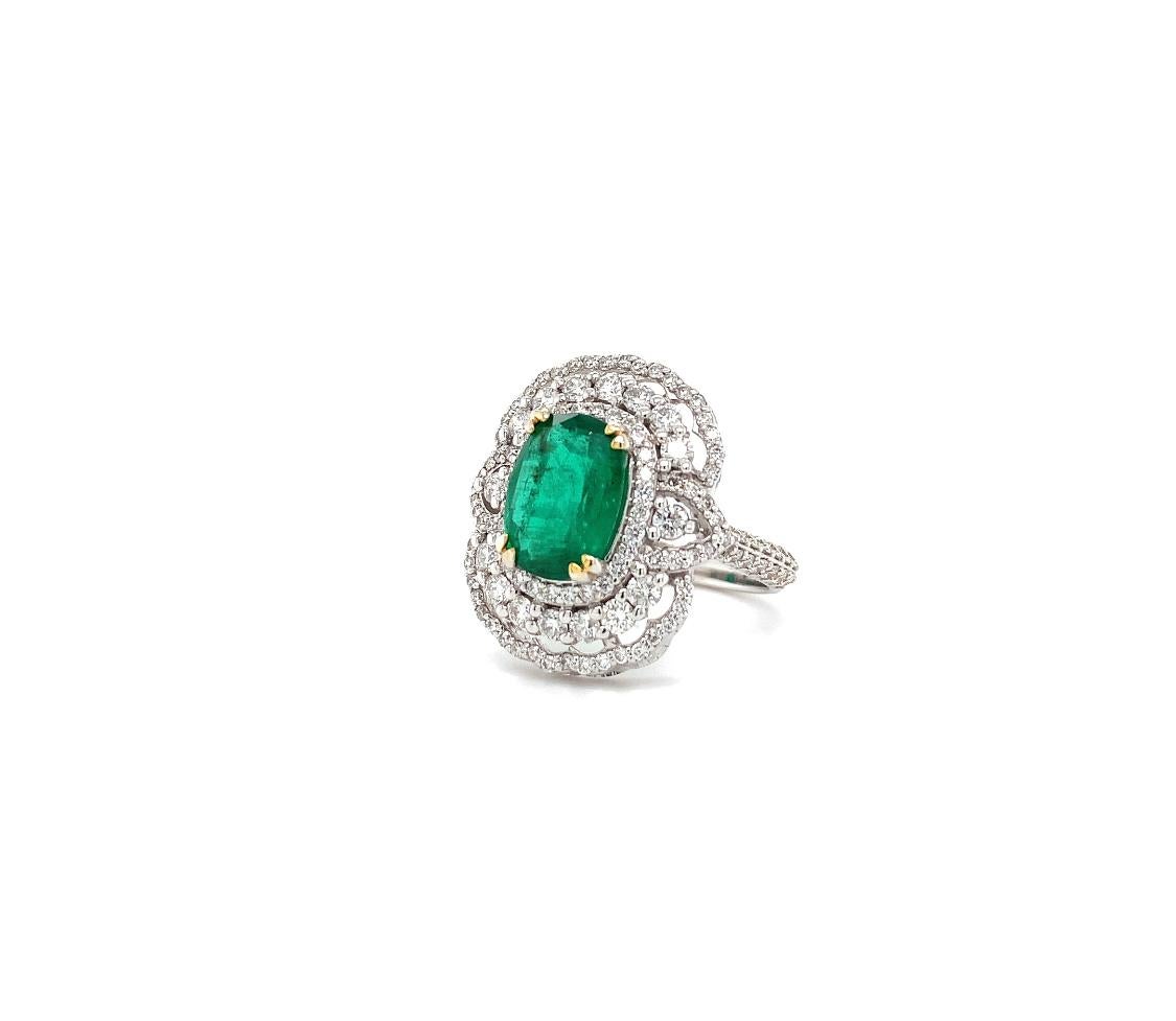 Natural green Zambian emerald and diamond halo cocktail ring in 18k white gold.
Zambia known for its wealth of gemstones and it is still one of the most valuable green emerald sources in the world.
The oval shaped emerald is set in a ring and